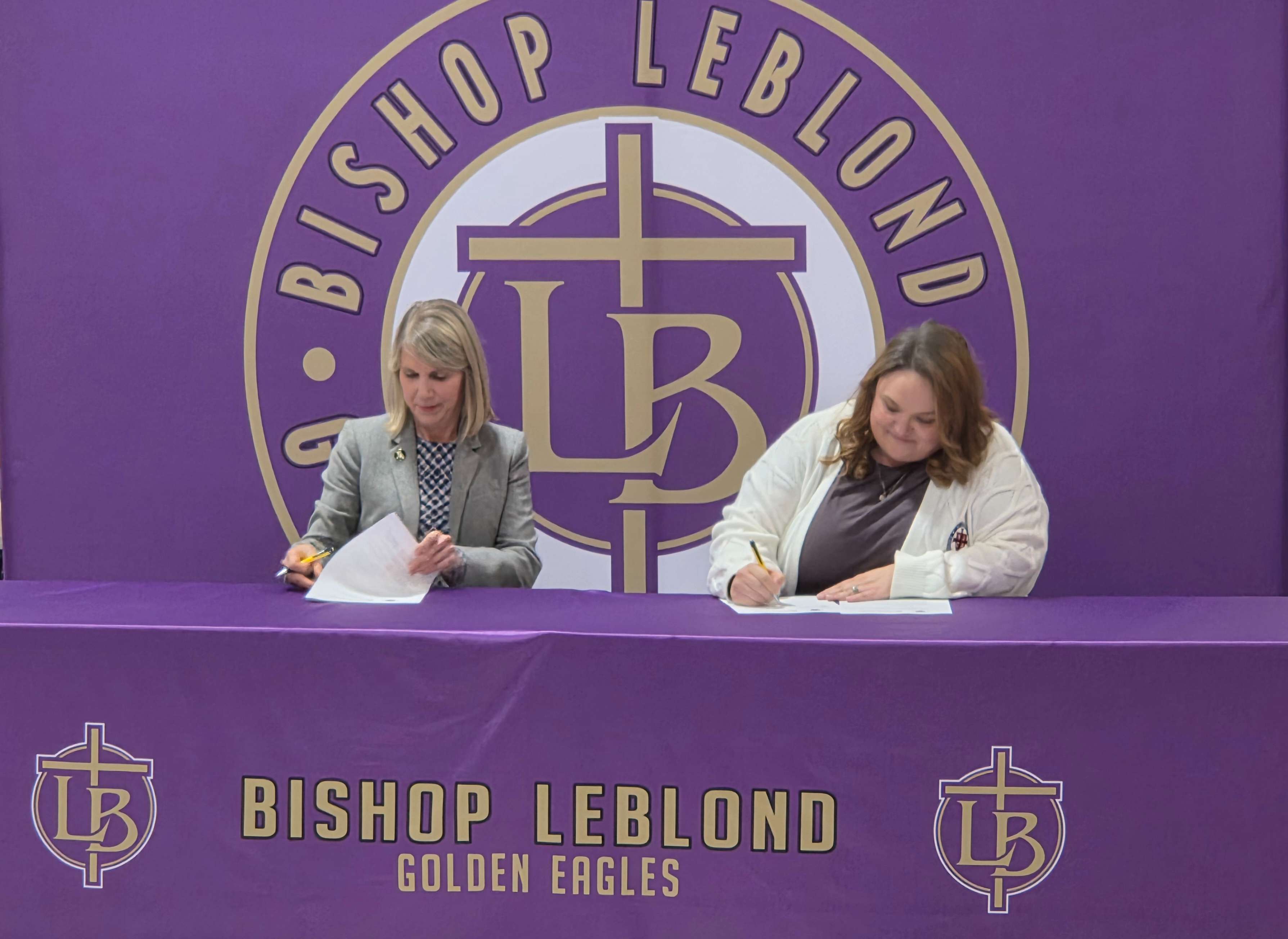 Missouri Western State University President Elizabeth Kennedy and St. Joseph Catholic Academy President Natalie Newville sign an agreement giving students at Bishop LeBlond High School direct admission to MoWest/ Photo by Matt Pike