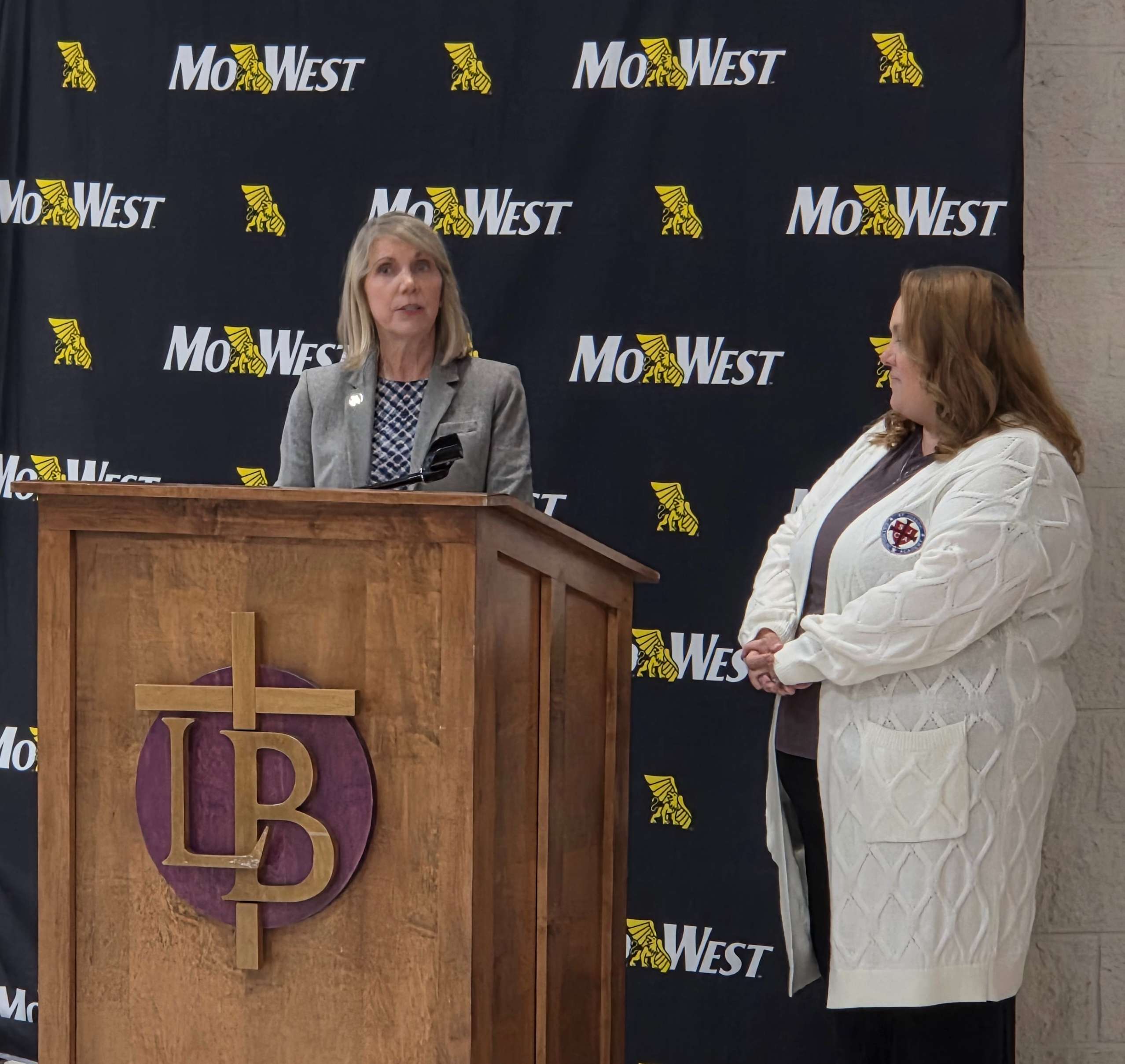 MoWest President Elizabeth Kennedy speaks as St. Joseph Catholic Academy President Natalie Newville looks on/ Photo by Matt Pike