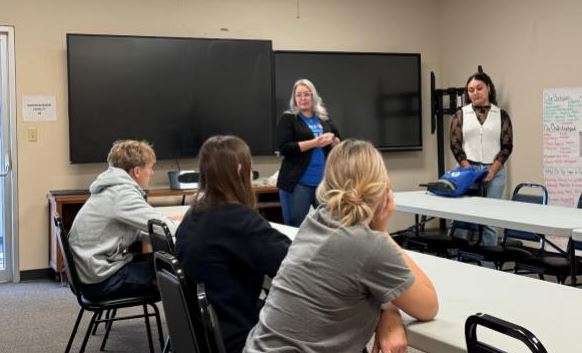 Jennifer Harman, standing at left, and her colleague, Daniela Reyes, both of BMO Bank in Larned, lead a financial-literacy discussion. The class was part of the Juvenile Services Life Skills program.