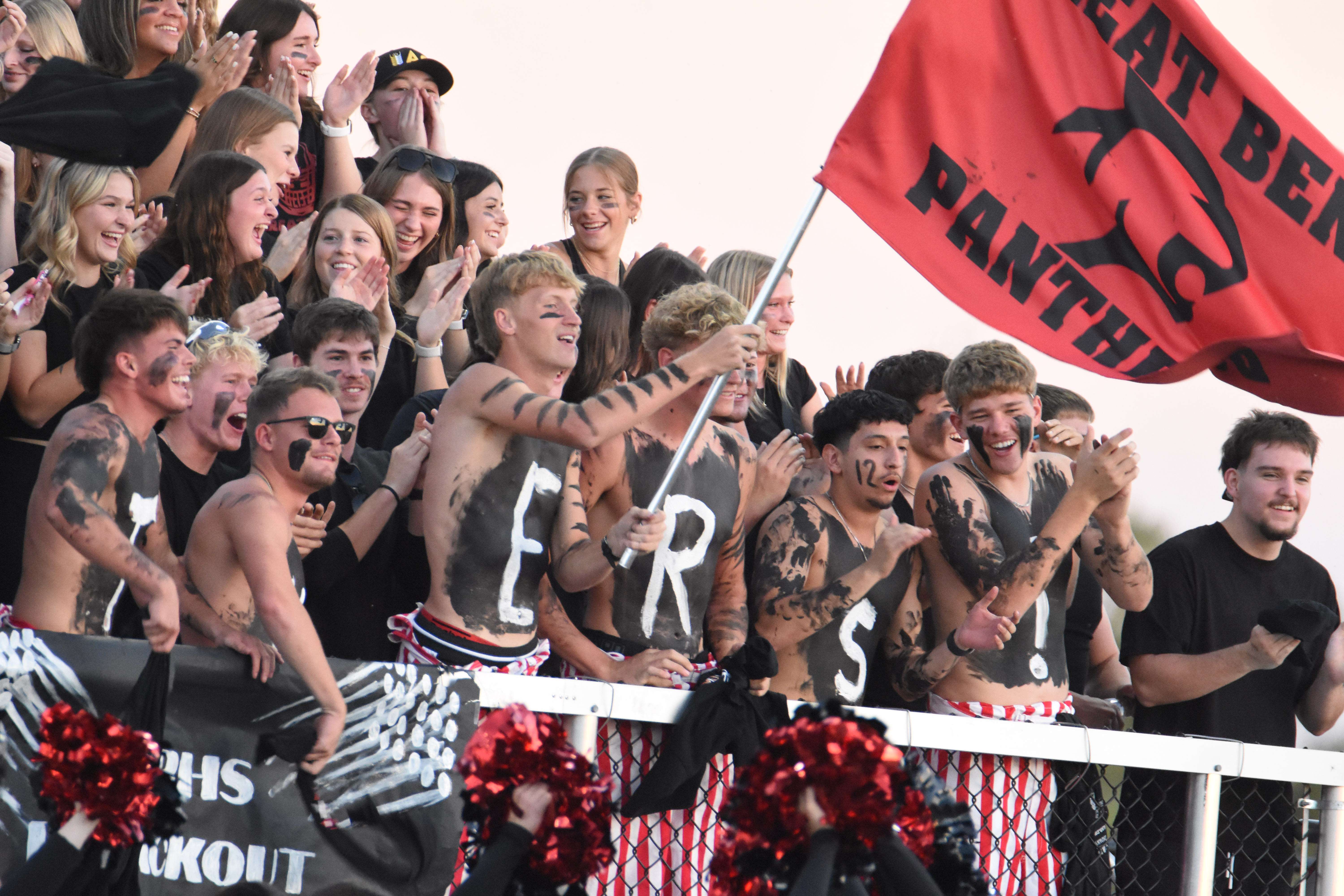 Stroup (with the flag) lead the crowd during a 43-19 win by the Panther football team in Hays on Oct. 17. (photo by Mike Courson)