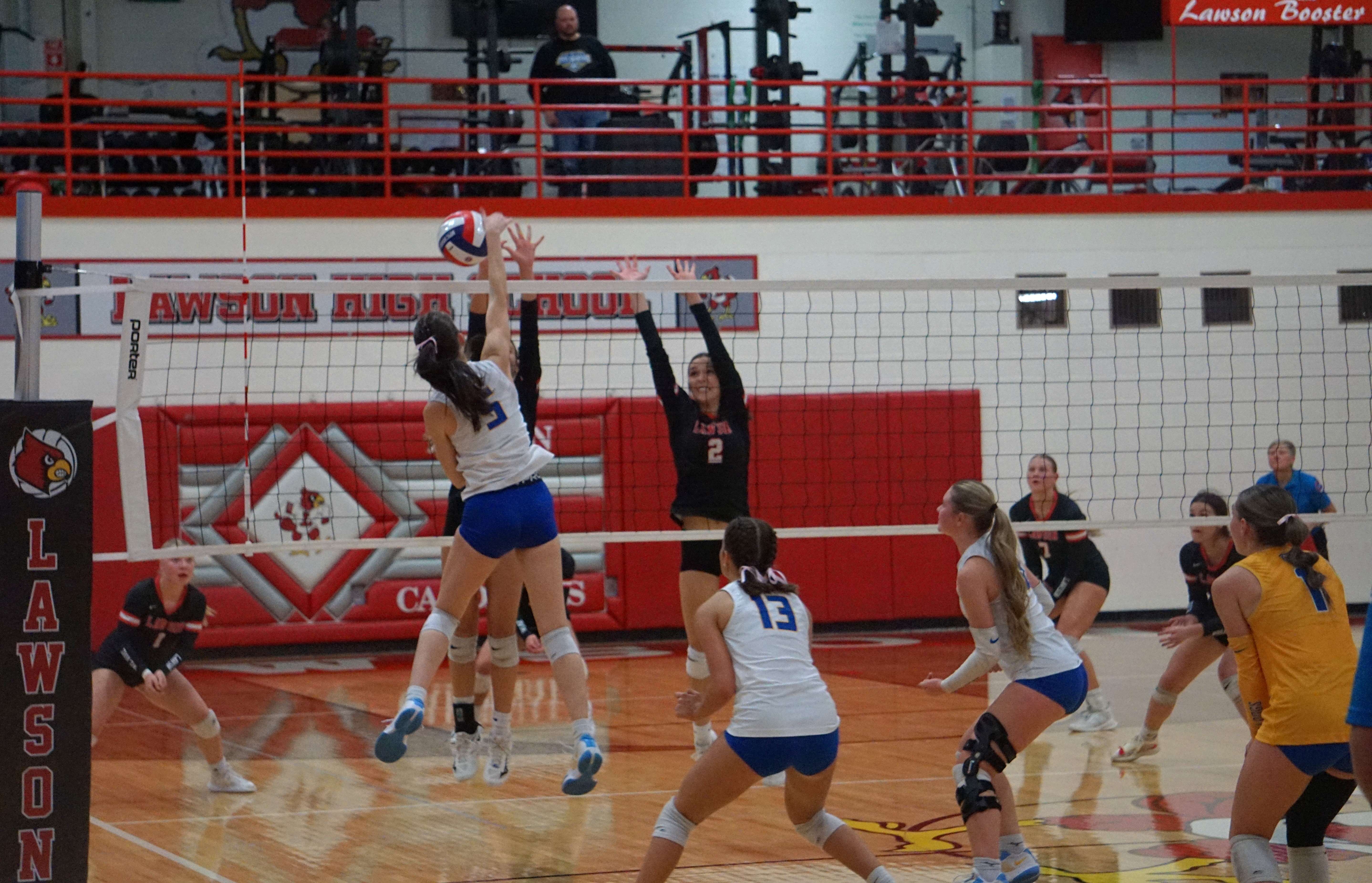 Kamryn Werle (5) spikes the ball over the net/ Photo by Matt Pike