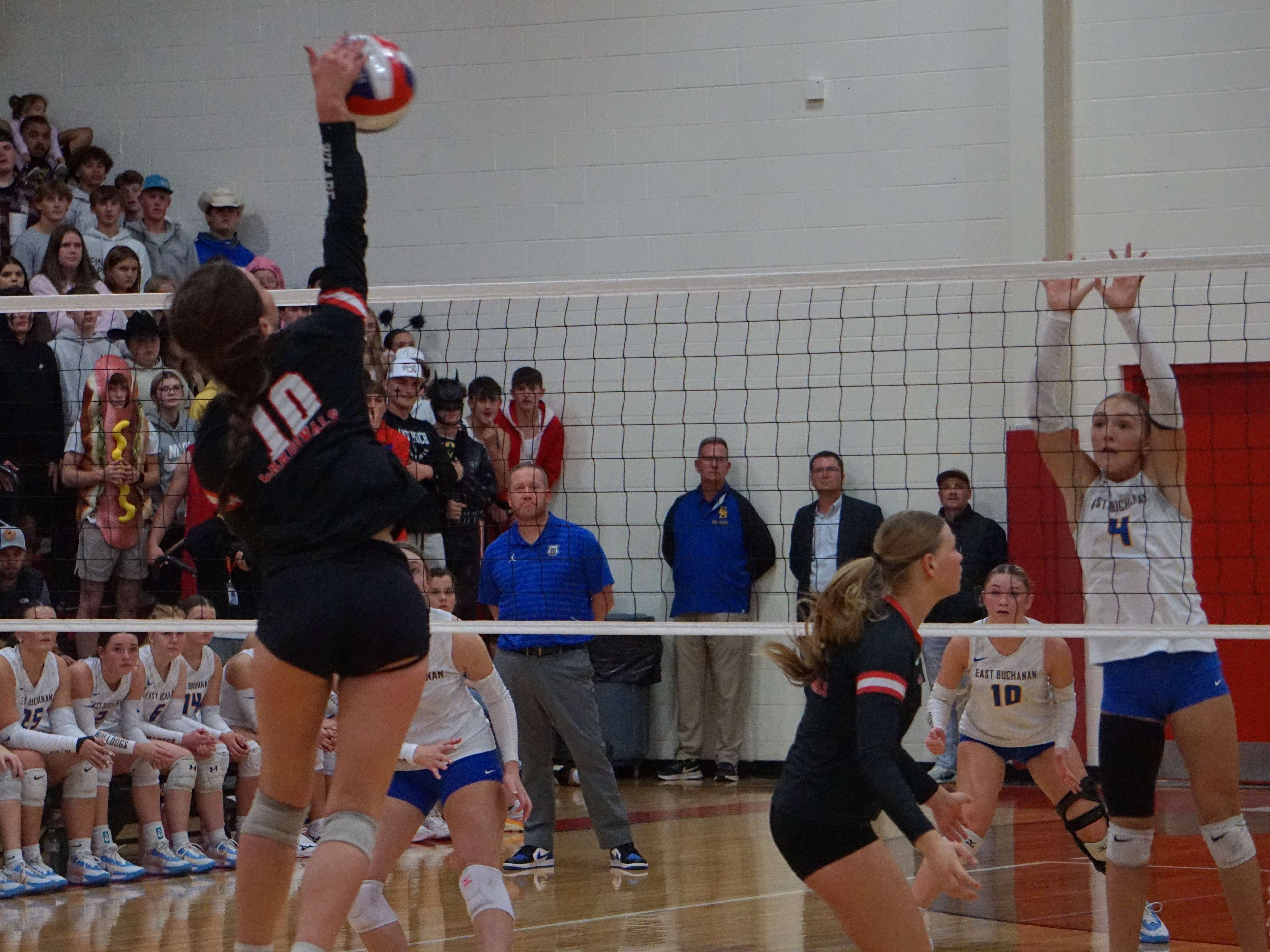 Lawson's Philamena Caresia (10) goes for the spike as East Buchanan's Kourtney Keling (4) goes for the block/ Photo by Matt Pike