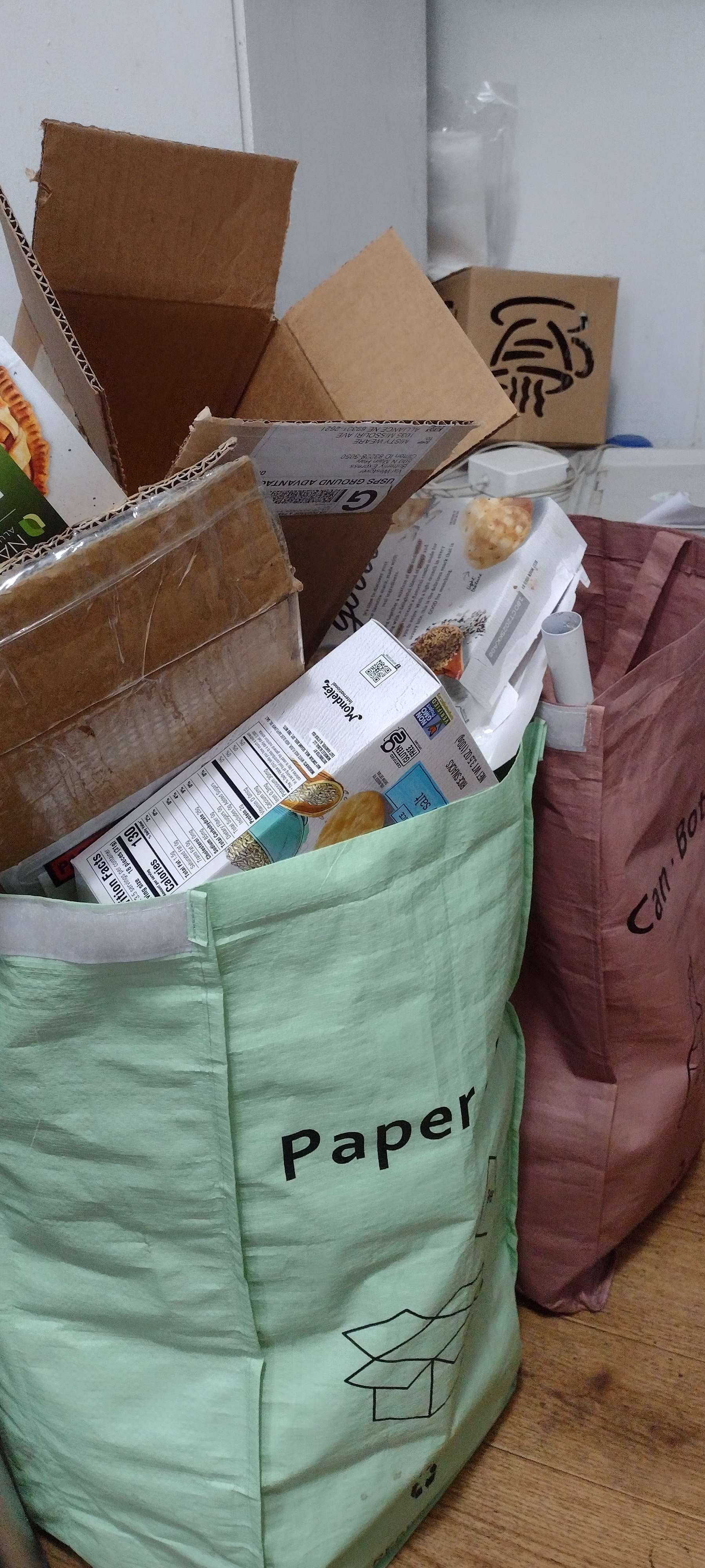A bag of boxes overflows. Celebrate America Recycles Day Nov. 15.