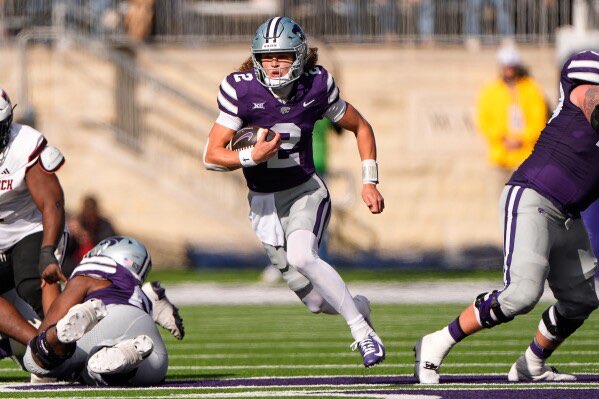 Kansas State quarterback Avery Johnson runs the ball during the first half of an NCAA college football game against Texas Tech, Saturday, Nov. 1, 2025, in Manhattan, Kan. (AP Photo/Charlie Riedel)