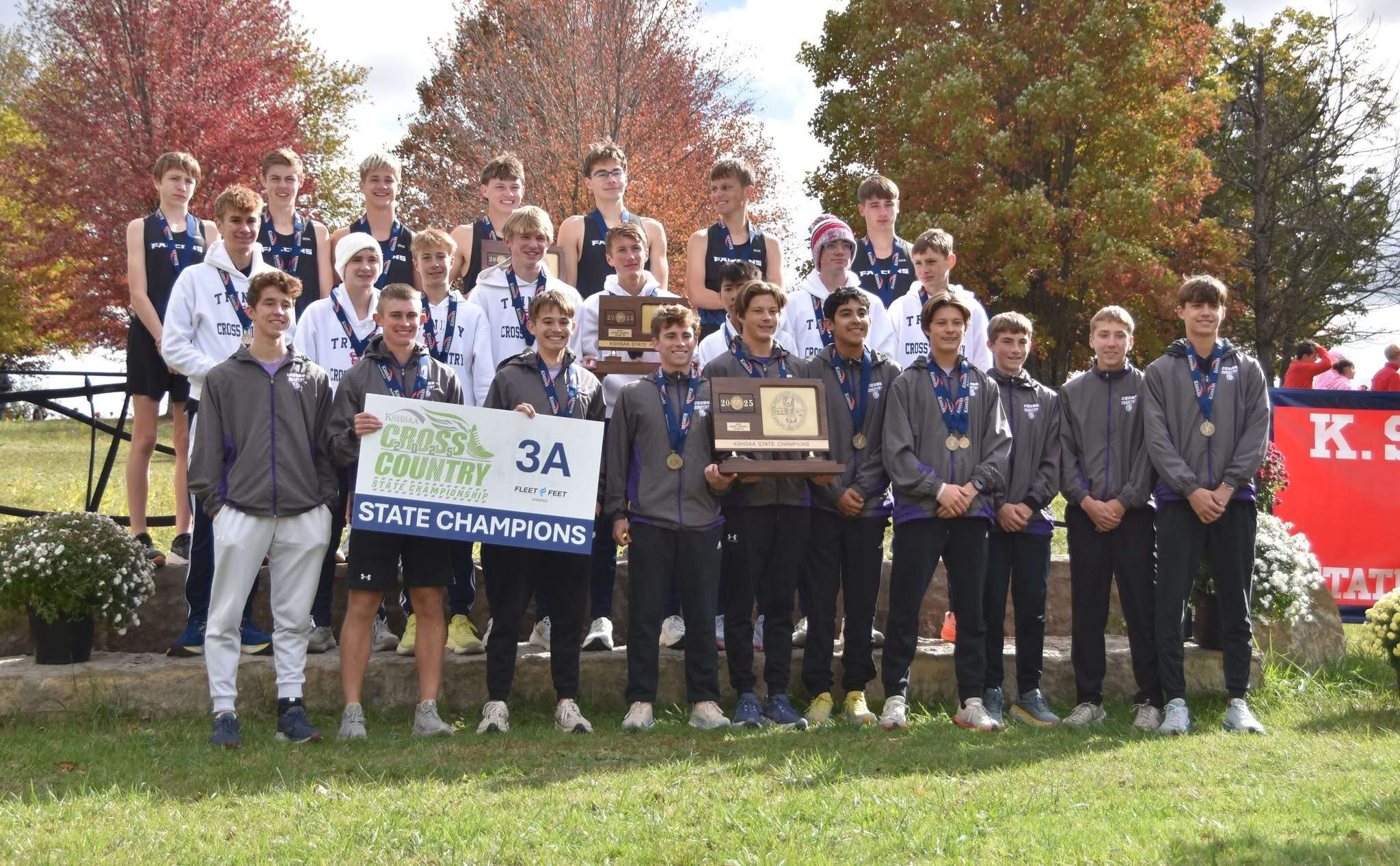 The Southeast of Saline boys' cross country team proudly holds the 3A state champion trophy. Photo courtesy of Jeremy Obermyer.
