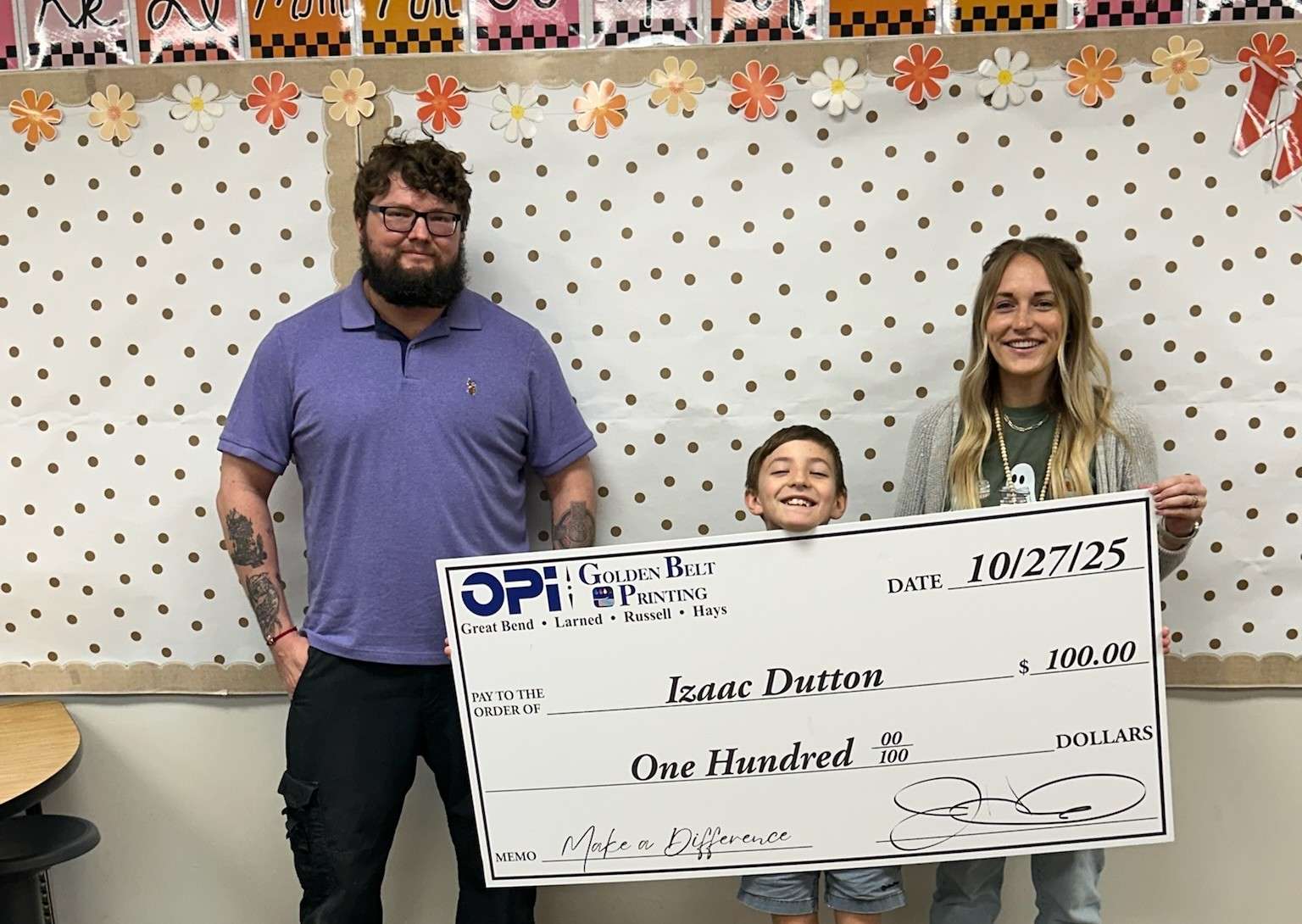 Will from OPI and Golden Belt Printing presented Hoisington fifth grader Izaac Dutton with a giant $100 check last week. Dutton is the latest winner in Eagle Media's Make a Difference Contest, presented by OPI and Golden Belt Printing. Dutton and his teacher, Stephanie Lomas, are now eligible for a monthly prize.