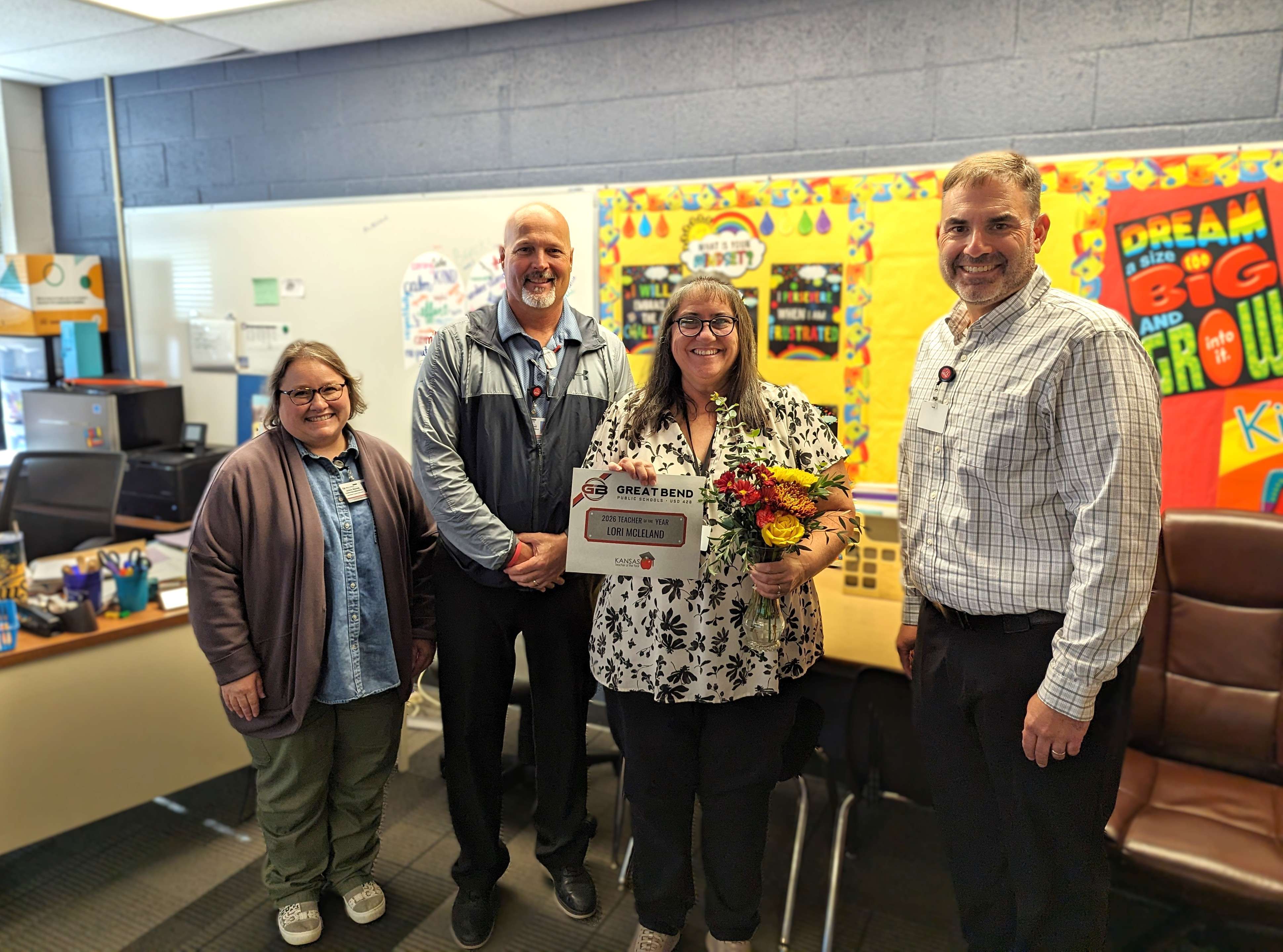 JoAnn Blevins, USD 428 Assistant Superintendent; Myron Ellegood, GBMS Principal; Lori McLeland, 2026 Secondary Teacher of the Year; and Khris Thexton, USD 428 Superintendent, gathered in McLeland’s 7th-grade English classroom at Great Bend Middle School to celebrate her selection as the 2026 USD 428 Secondary Teacher of the Year.