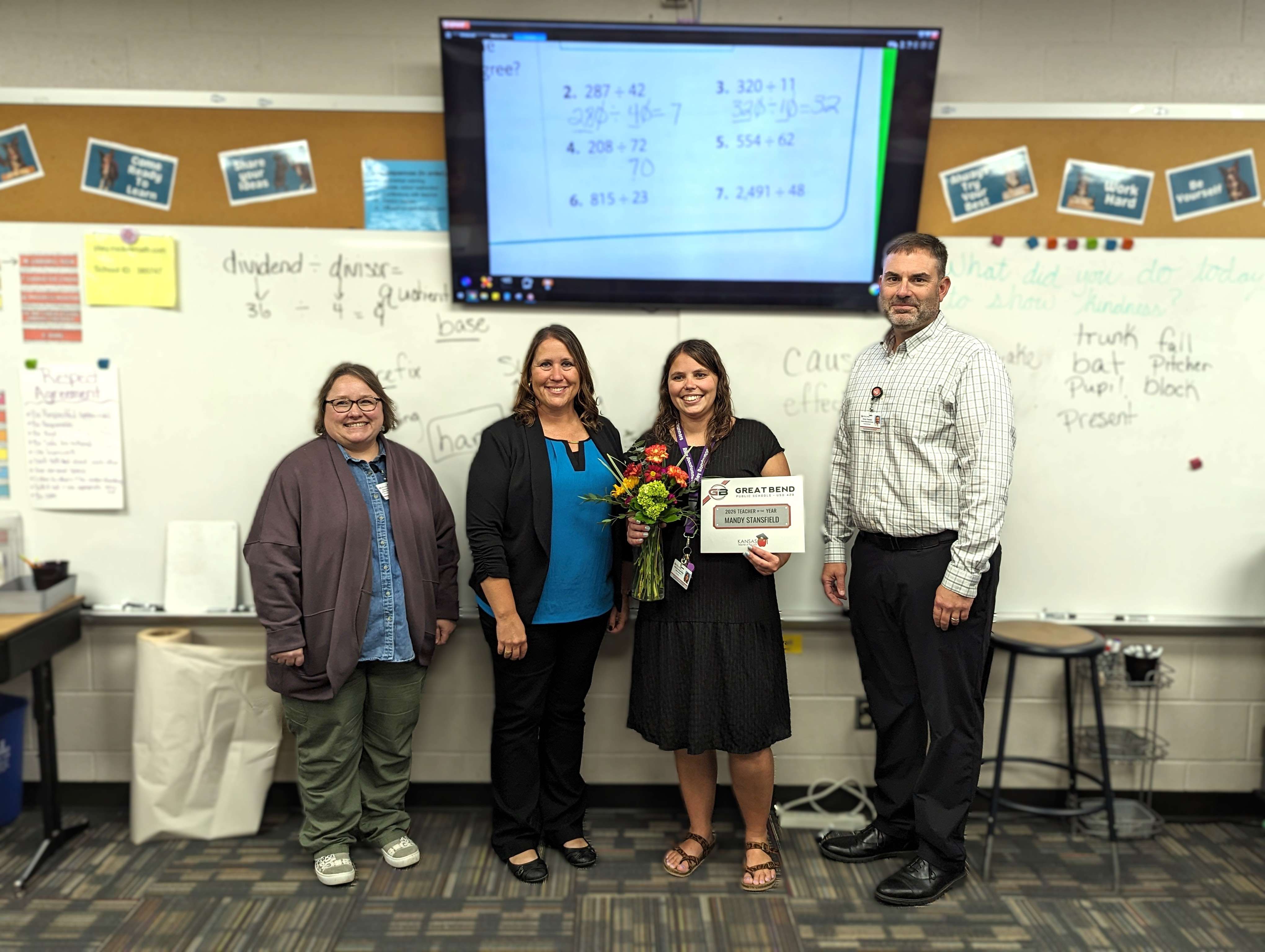 USD 428 administrators stopped by Ms. Stansfield’s classroom to award her the 2026 Teacher of the Year honor, surprising her and her students during a math lesson. JoAnn Blevins, USD 428 Assistant Superintendent; Lisa Starr, Riley Elementary Principal; Mandy Stansfield, 2026 Elementary Teacher of the Year; and Khris Thexton, USD 428 Superintendent.