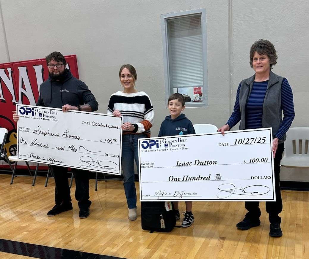 Will and Tina from OPI returned to Hoisington's Lincoln Elementary last week to give fifth-grader Izaac Dutton and his teacher, Stephanie Lomas, checks for $100 as monthly winners in Eagle Media's Make a Difference Contest.