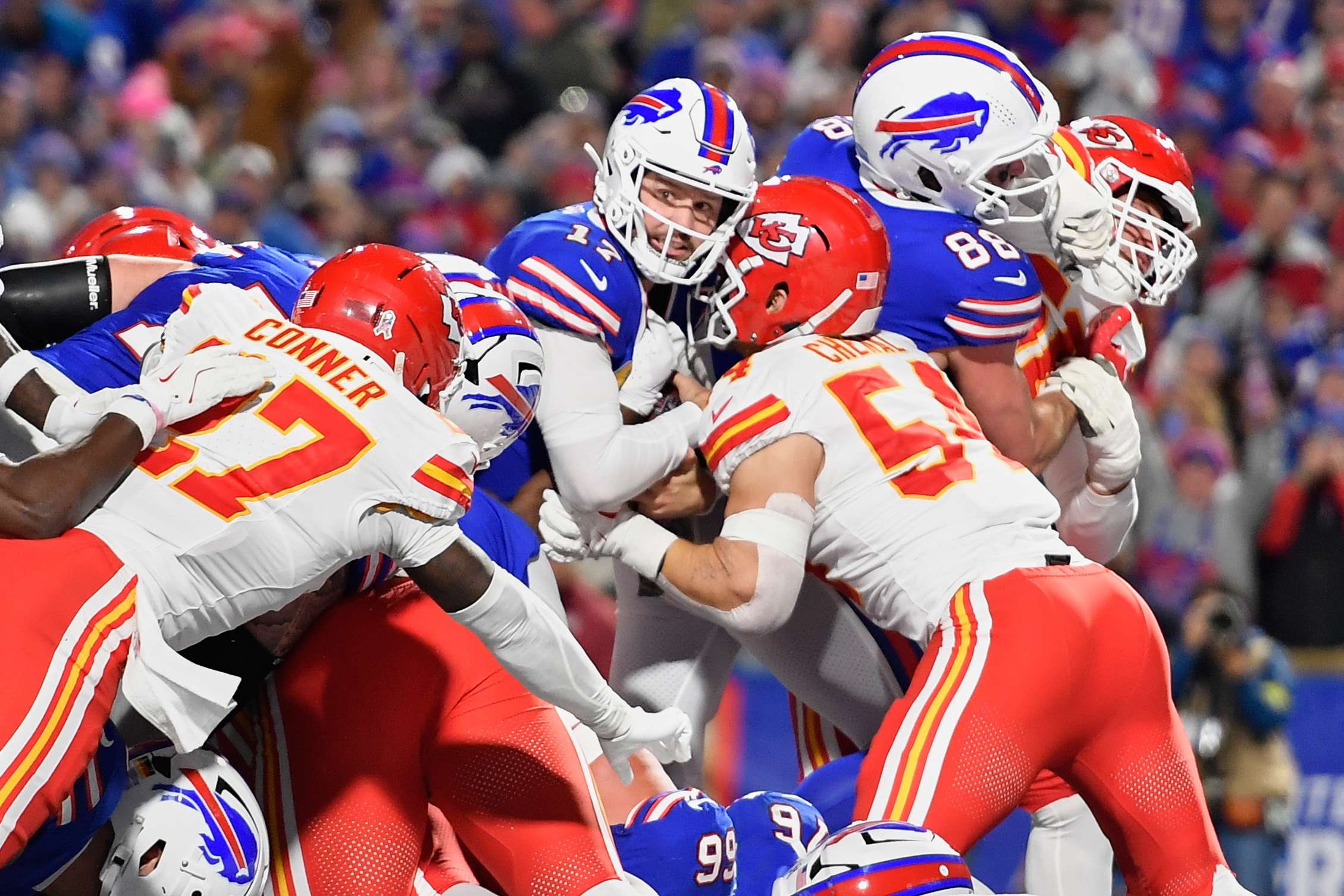 Buffalo Bills quarterback Josh Allen (17) scores as Kansas City Chiefs linebacker Leo Chenal (54) and defensive back Chamarri Conner, left, defend during the first half of an NFL football game Sunday, Nov. 2, 2025, in Orchard Park. N.Y. (AP Photo/Adrian Kraus)