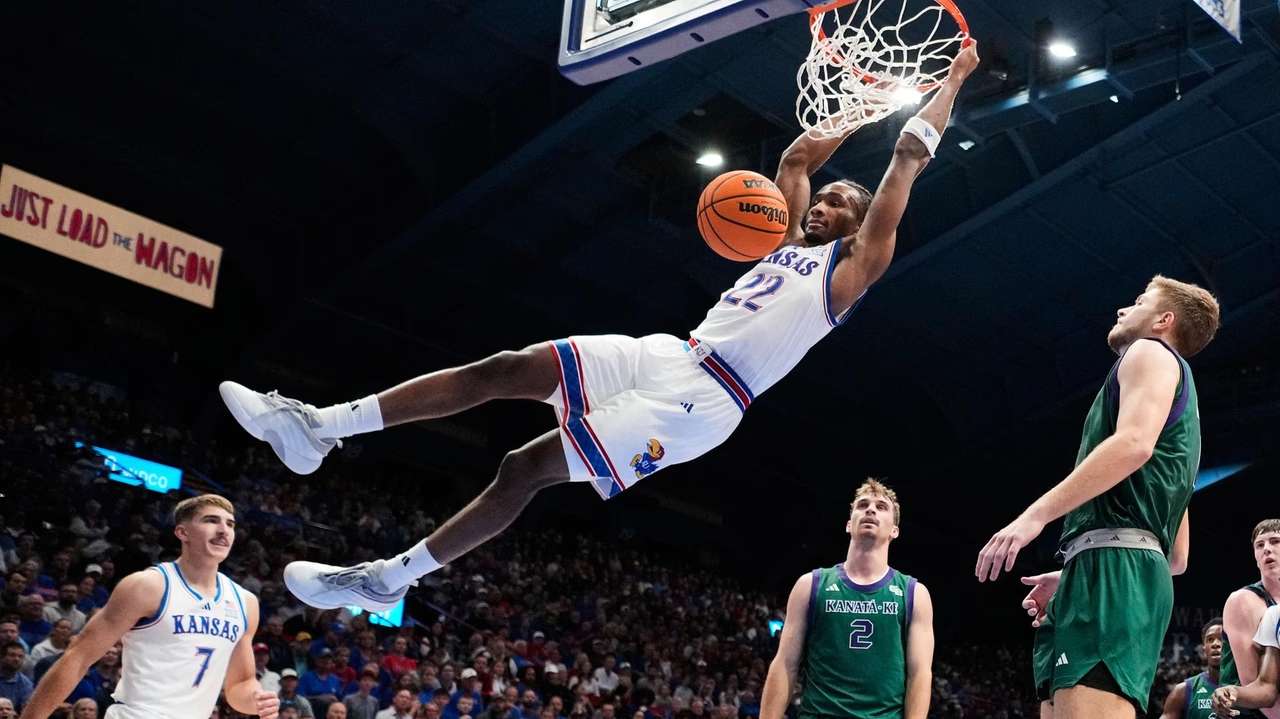 Kansas guard Darryn Peterson dunks the ball during the first half of an NCAA college basketball game against Green Bay, Monday, Nov. 3, 2025, in Lawrence, Kan. (AP Photo/Charlie Riedel)