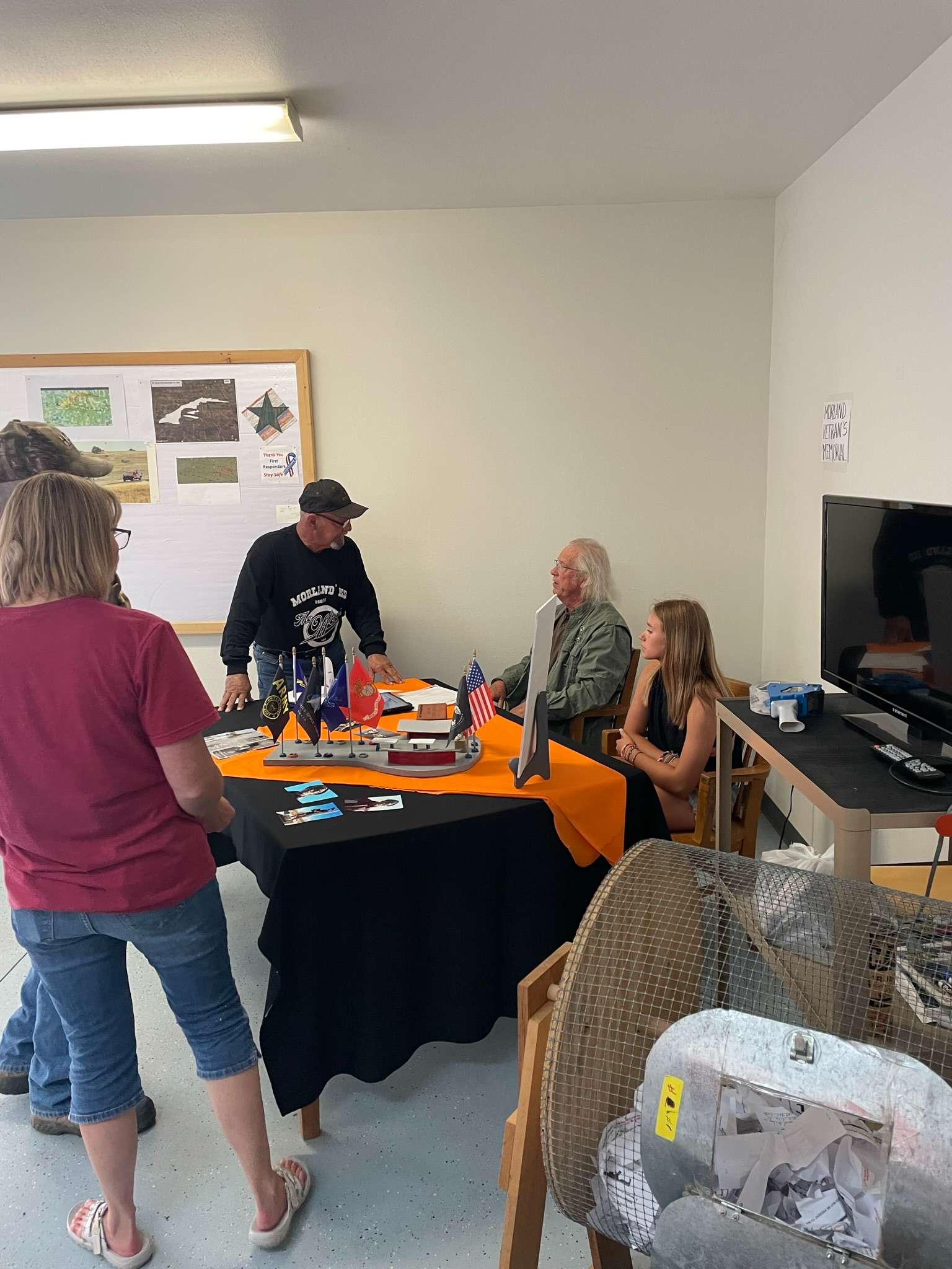 <i>Sgt. Ray Toll and his granddaughter, Winter, talking with residents about our project. Courtesy photo</i>