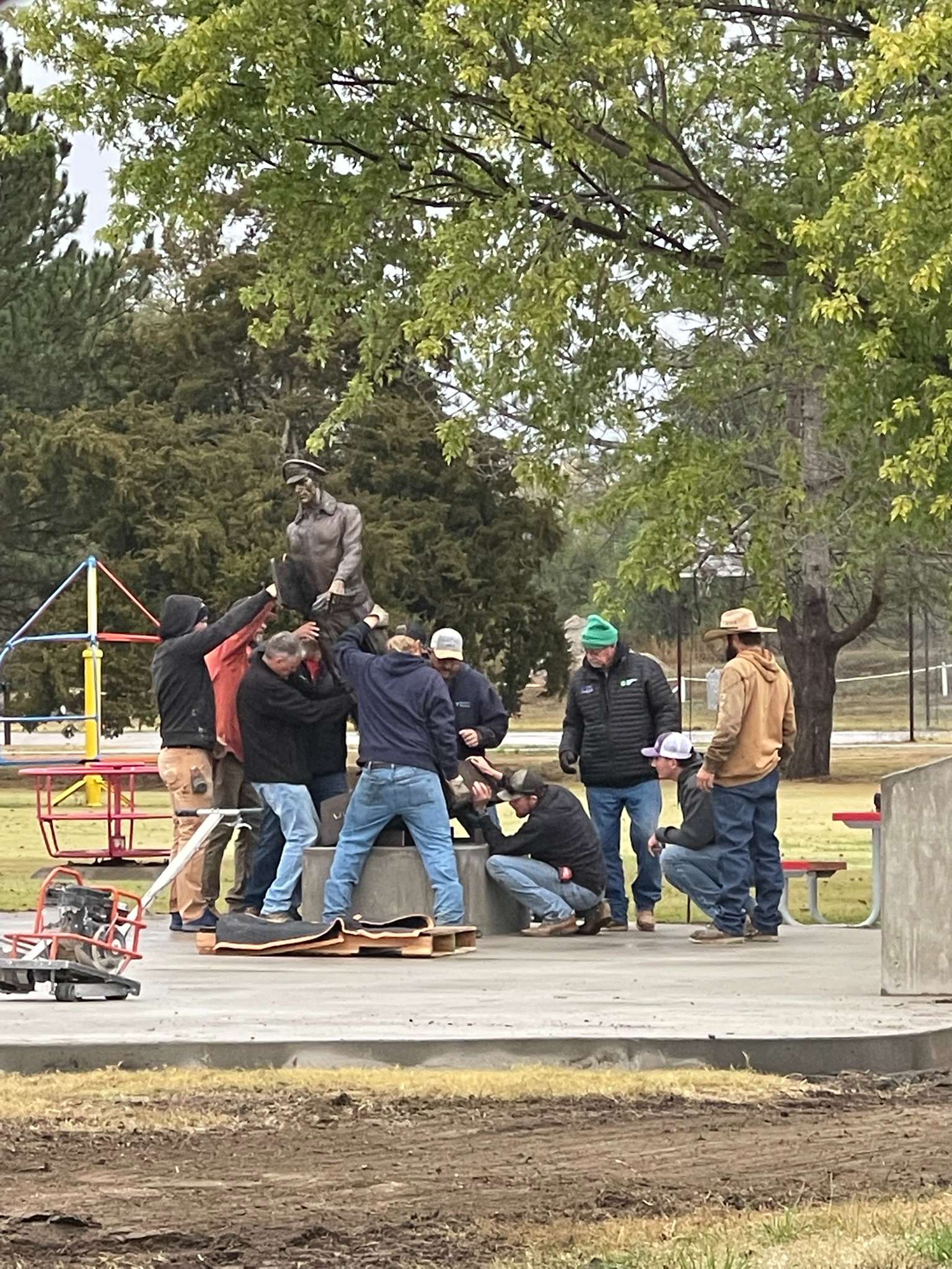<i>Morland firefighters placing a statue in the park. Courtesy photo</i>
