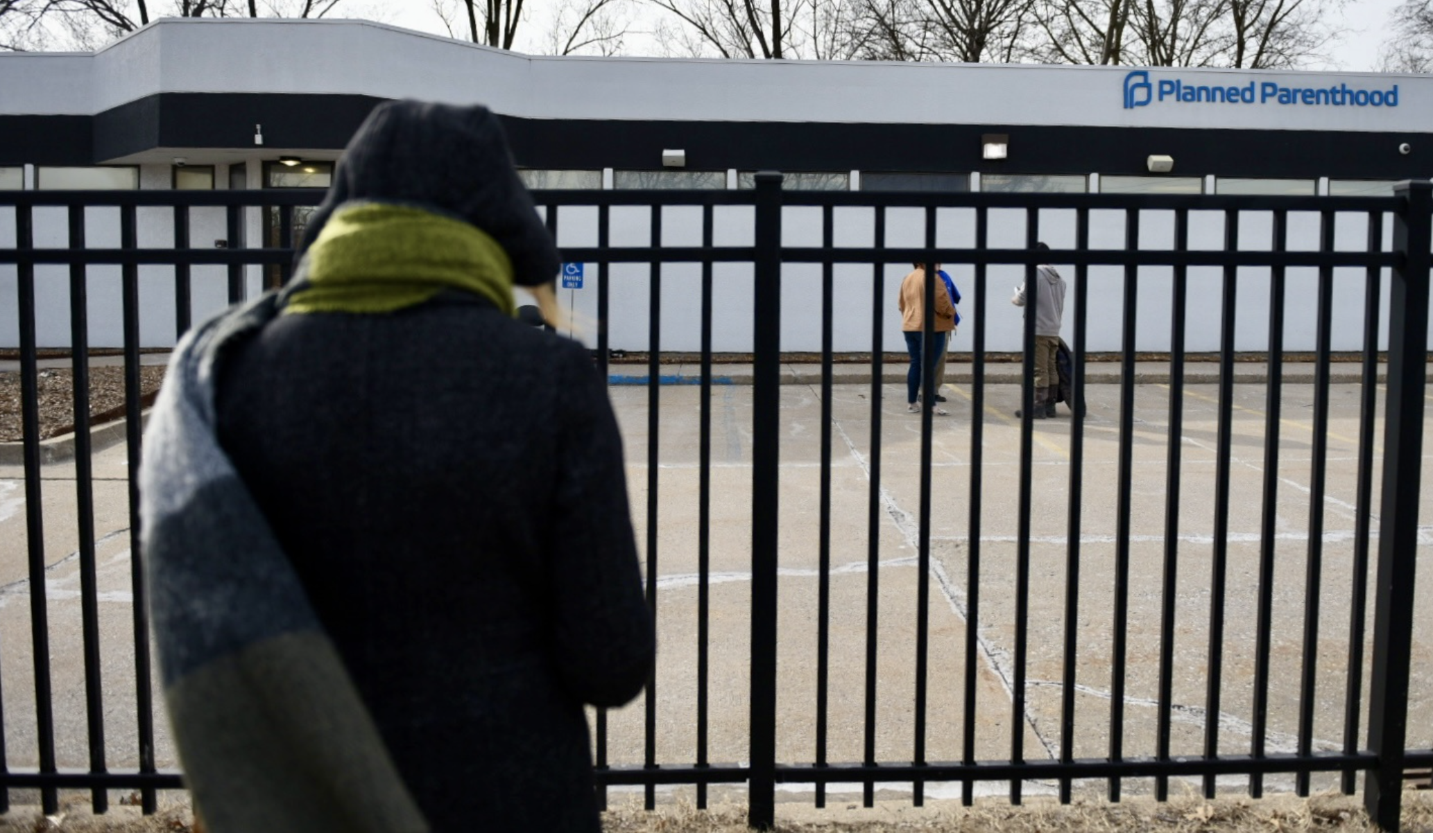 Connie Gerling, with 40 Days for Life, prays as she stands outside the Columbia Planned Parenthood clinic on Monday, March 3, 2025. A sign beside her reads: “We Care. We can Help” (Anna Spoerre/Missouri Independent).