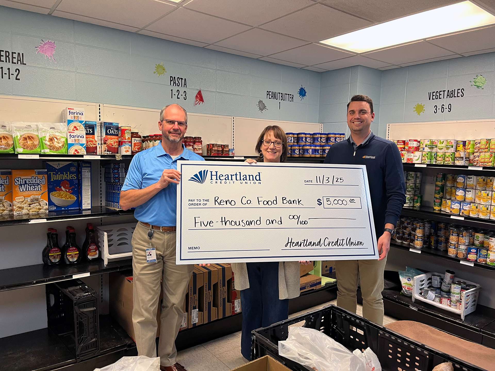 (L-R): Darren Werth, AVP of Community Government Affairs for Heartland, Angela Penner, Reno County Food Bank Executive Director, and Trace Hughes, VP of Brand and Marketing for Heartland. (Photo Courtesy Heartland Credit Union)