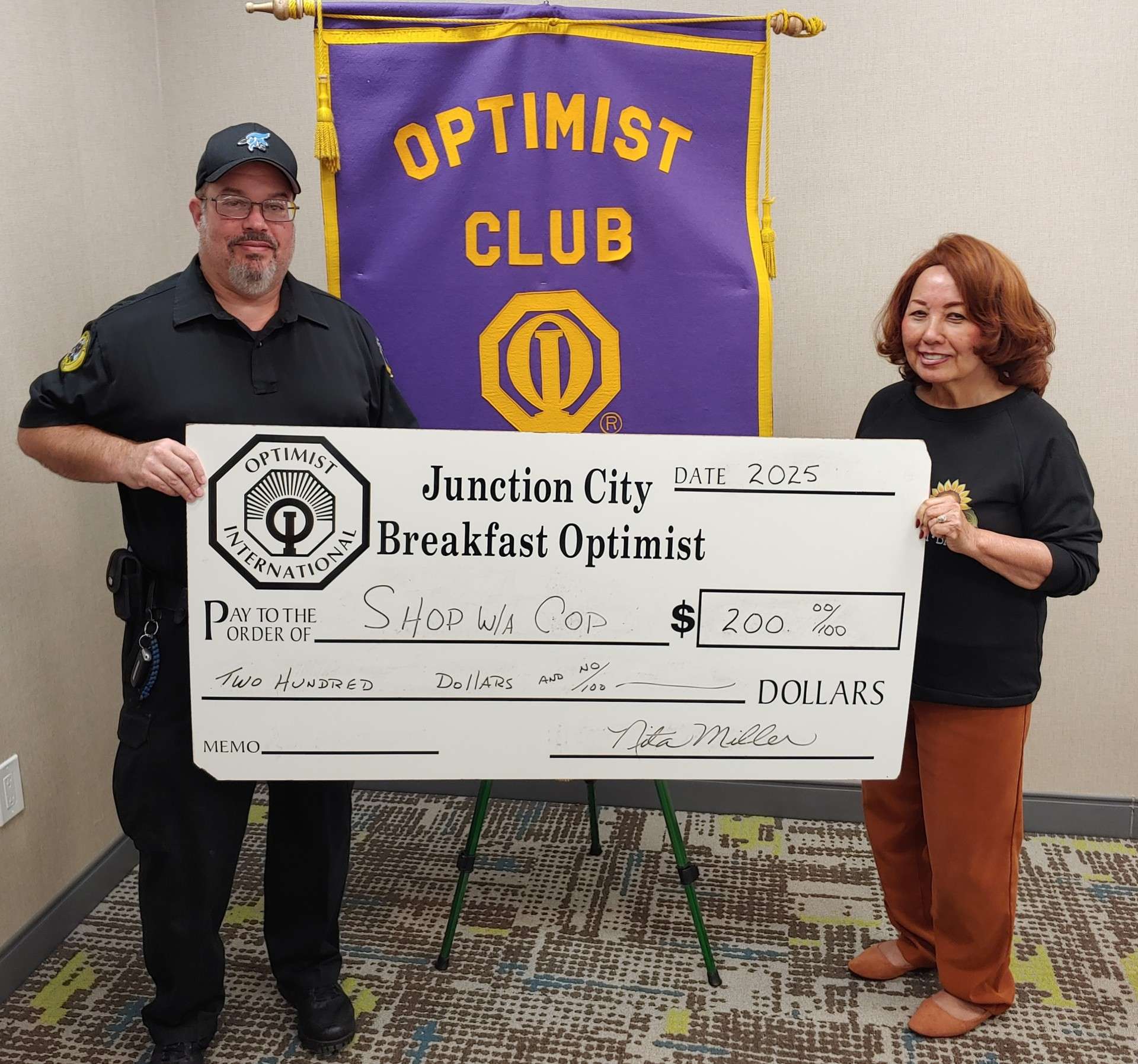 Pictured right to left are JC Breakfast Optimist Club President, Nita Miller and Officer Eddie Torres with the Junction City Police Department. 