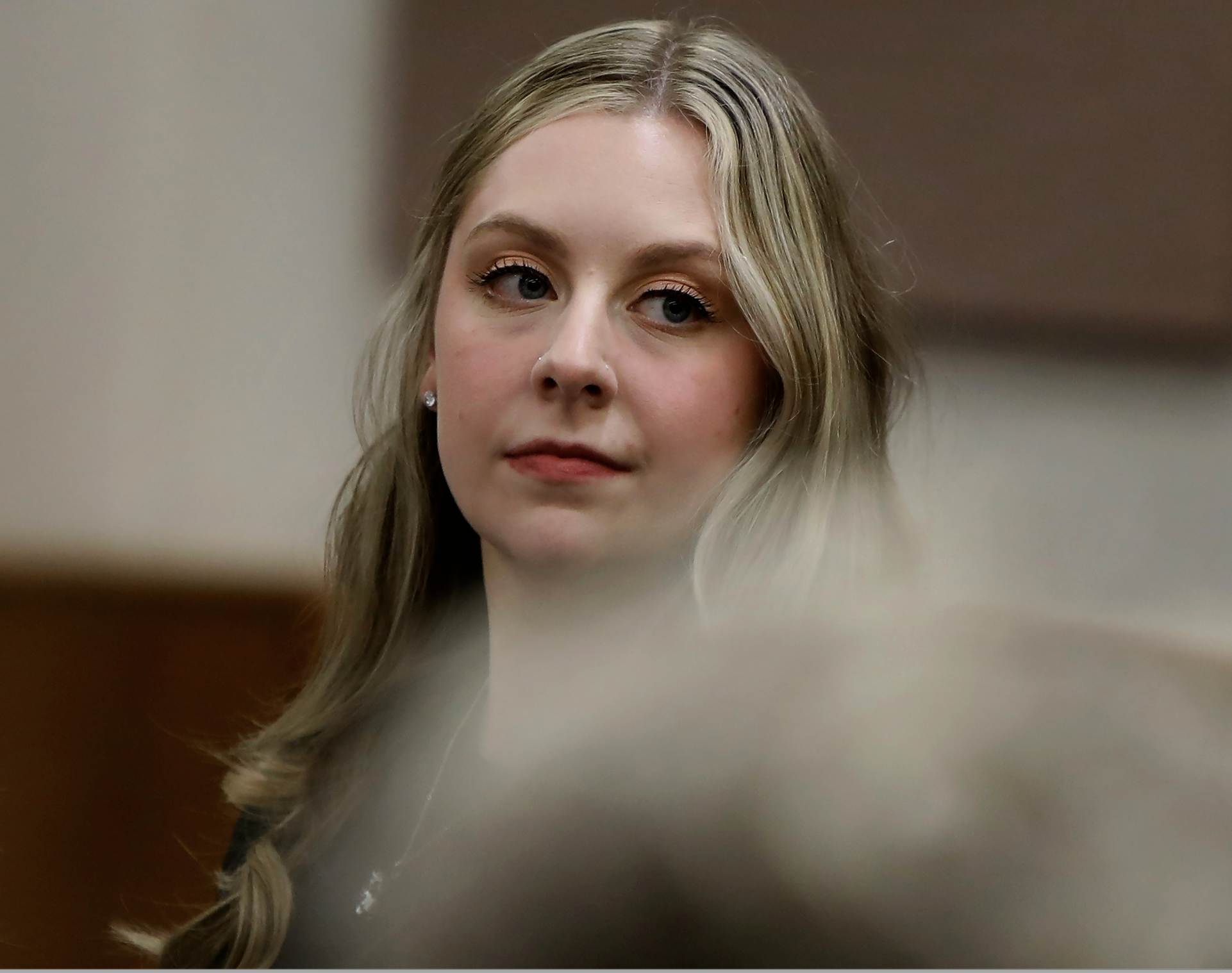 Former Richneck Elementary School teacher Abby Zwerner looks back into the courtroom during her civil lawsuit trial, Tuesday, Oct. 28, 2025, in Newport News, Va. (Stephen M. Katz/The Virginian-Pilot via AP, Pool)