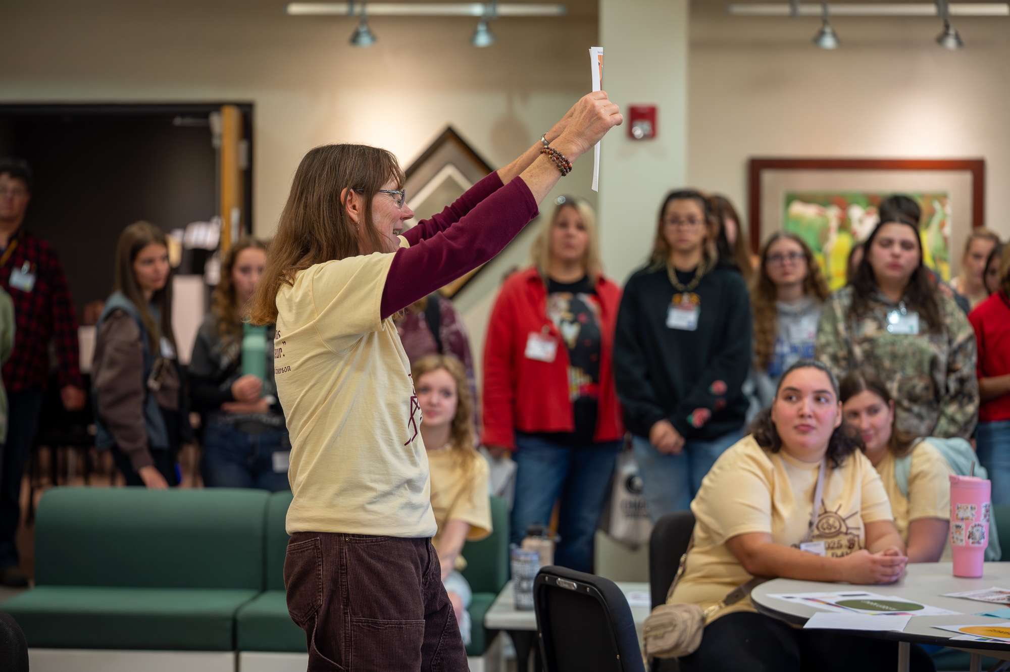 Professor Mary Donahue, center, explains the Art Day schedule to attendees from surrounding high schools in the Memorial Hall lobby, Nov. 4, 2025. (Photo by Sydney Brown/Chadron State College).