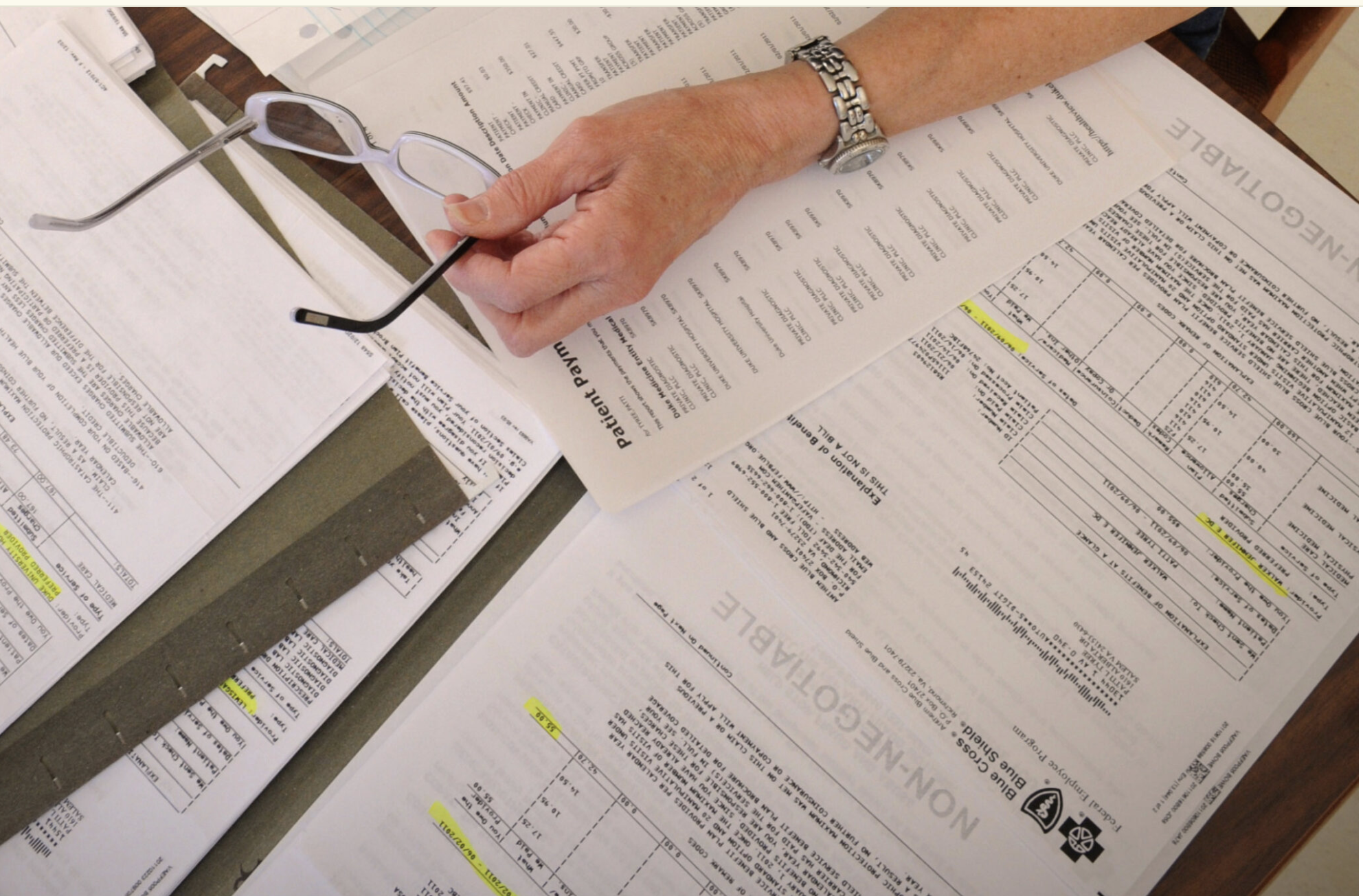 A cancer patient’s medical bills are spread on a kitchen table in a home in Salem, Va., in this 2011 file photo. A new Trump administration rule would override more than a dozen state laws that shield consumers’ credit reports from medical debt. (Photo by Don Petersen/Associated Press)