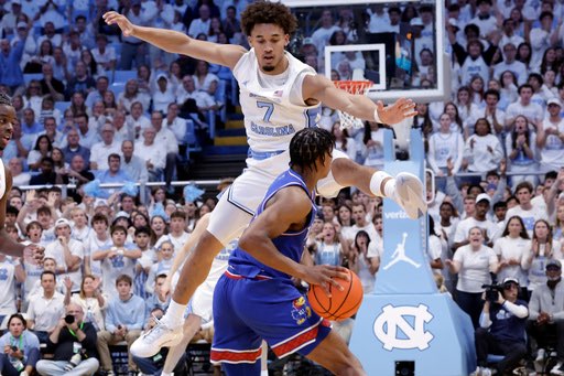North Carolina guard Seth Trimble (7) defends against Kansas guard Elmarko Jackson, bottom, during the first half of an NCAA college basketball game Friday, Nov. 7, 2025, in Chapel Hill, N.C. (AP Photo/Chris Seward)