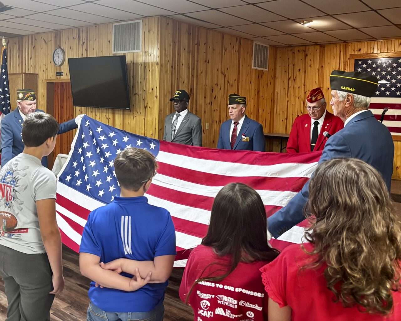 Retired Command Sgt. Maj. Ivanhoe Love and Mike Morley, commander of VFW Post 9076 in Hays, watching the flag-folding ceremony Tuesday at the Hays VFW. Photo by Tony Guerrero/Hays Post