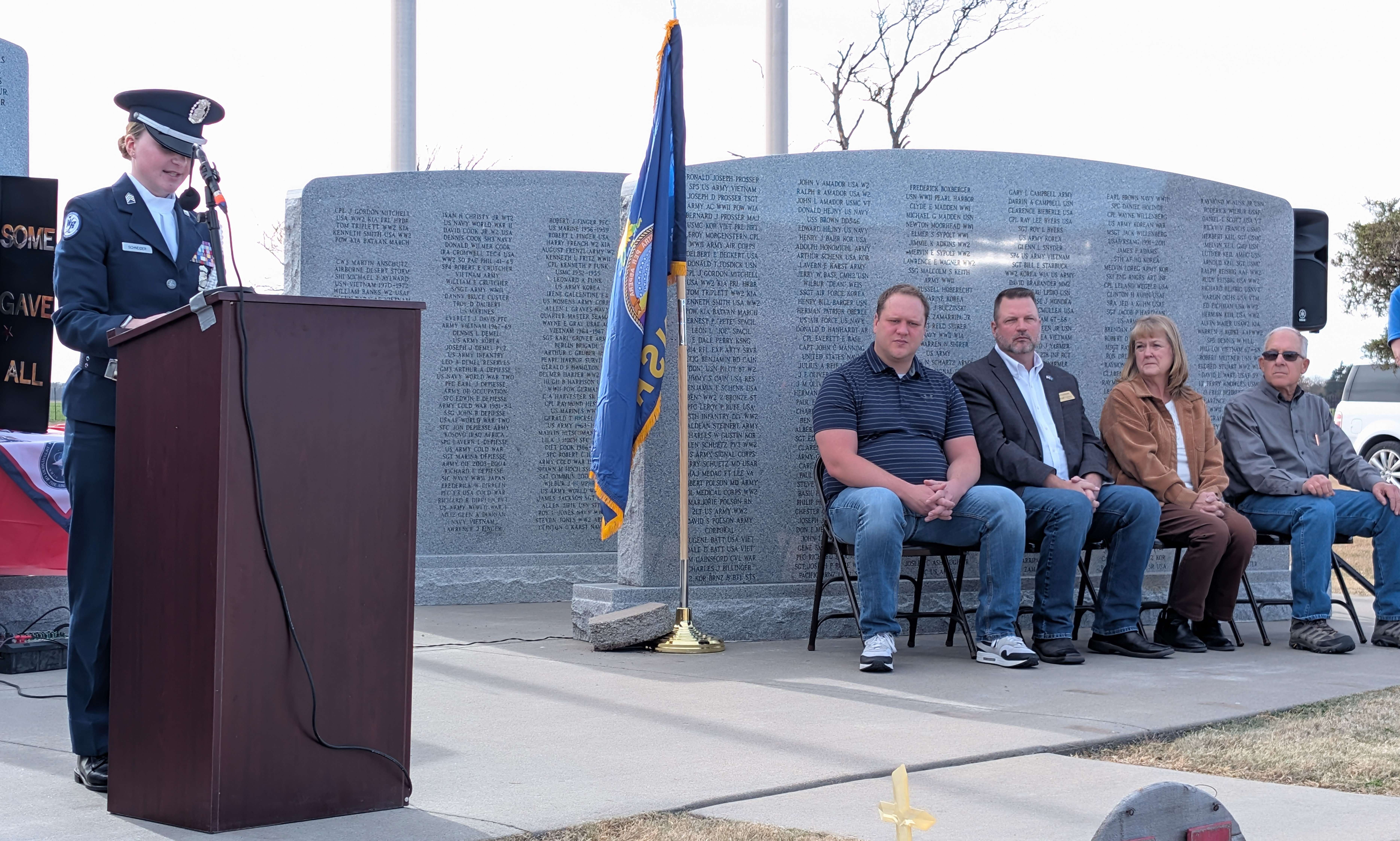 Washburn Rural High School Junior Air Force ROTC Cadet Kelcie Schneider, the granddaughter of Hoisington residents Norbert and Terry Schneider, thanks veterans past and present for their sacrifices Tuesday afternoon at the Golden Belt Veterans Memorial Veterans Day service. Also pictured are Barton County Administrator Matt Patzner, and commissioners Shawn Hutchinson, Barb Esfeld and Duane Reif.