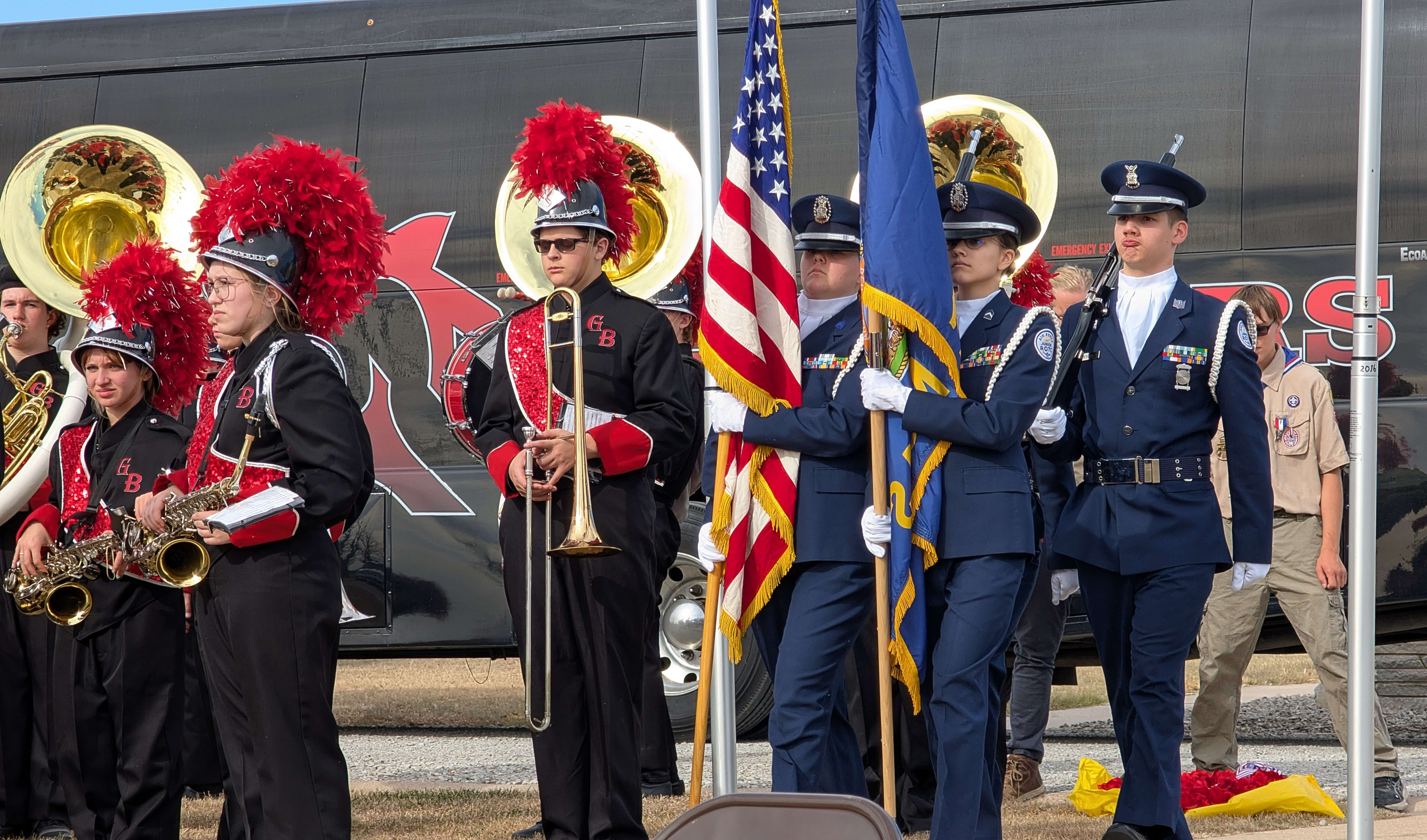 As the Great Bend High School marching band stands at the ready, the Washburn Rural High School Junior Air Force ROTC color guard present the colors during the Golden Belt Veterans Memorial Veterans Day observance Tuesday afternoon.