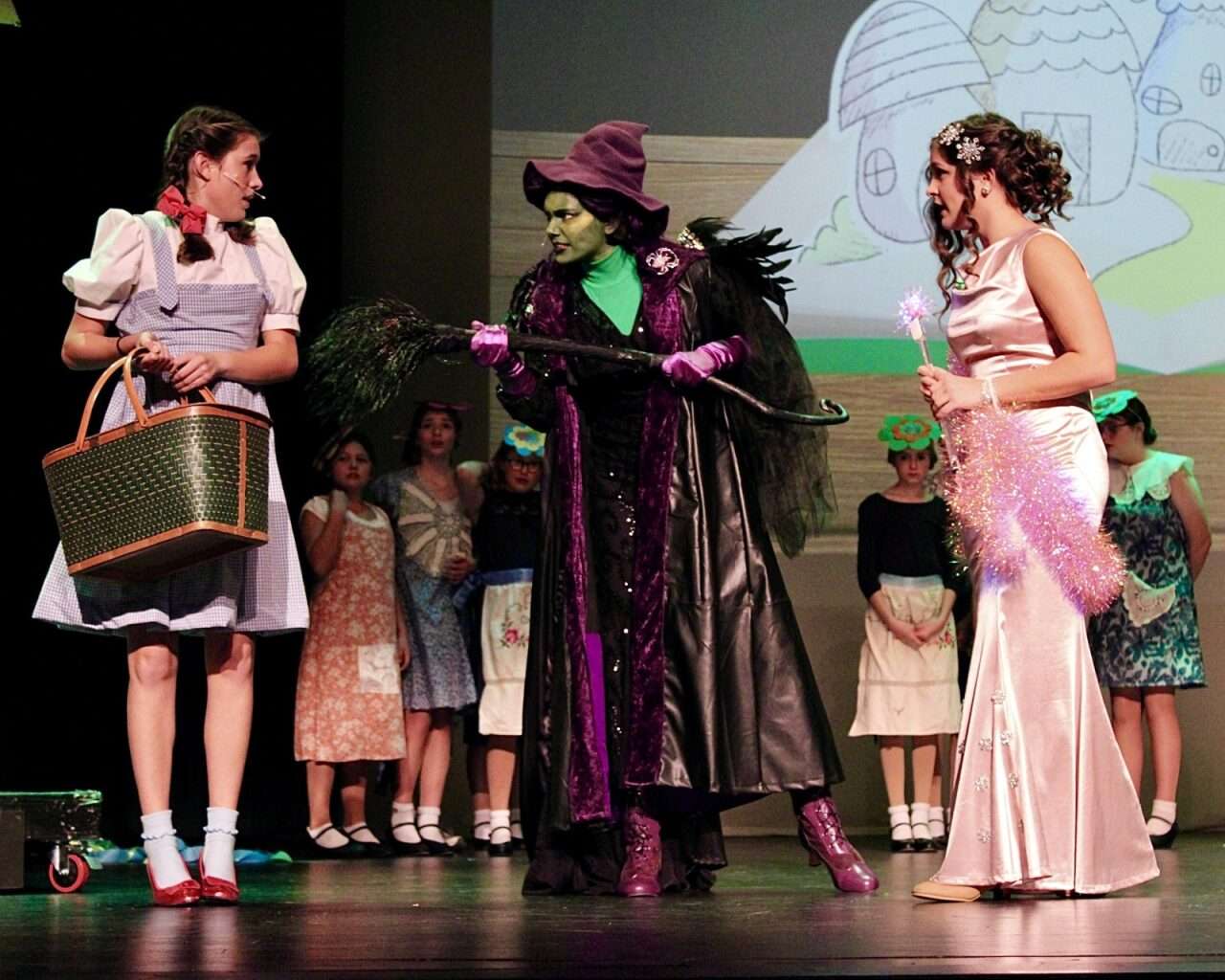 Dorothy Gale, the Wicked Witch of the West and Glinda taking center stage for Thomas More Prep-Marian's "The Wizard of Oz" production. Photo by Tony Guerrero/Hays Post
