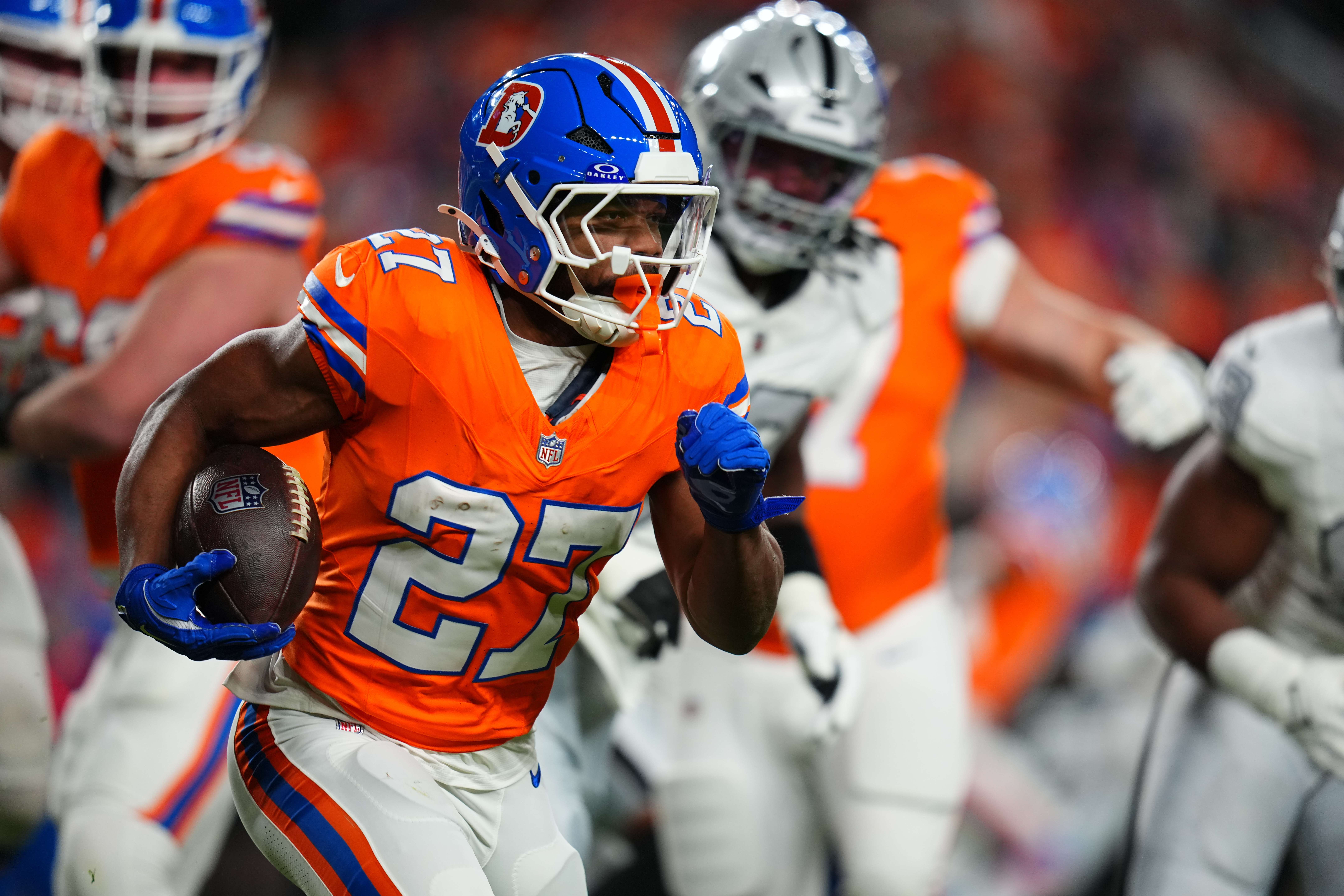 Denver Broncos running back J.K. Dobbins runs with the ball during the first half of an NFL football game against the Las Vegas Raiders Thursday, Nov. 6, 2025, in Denver. (AP Photo/Jack Dempsey)