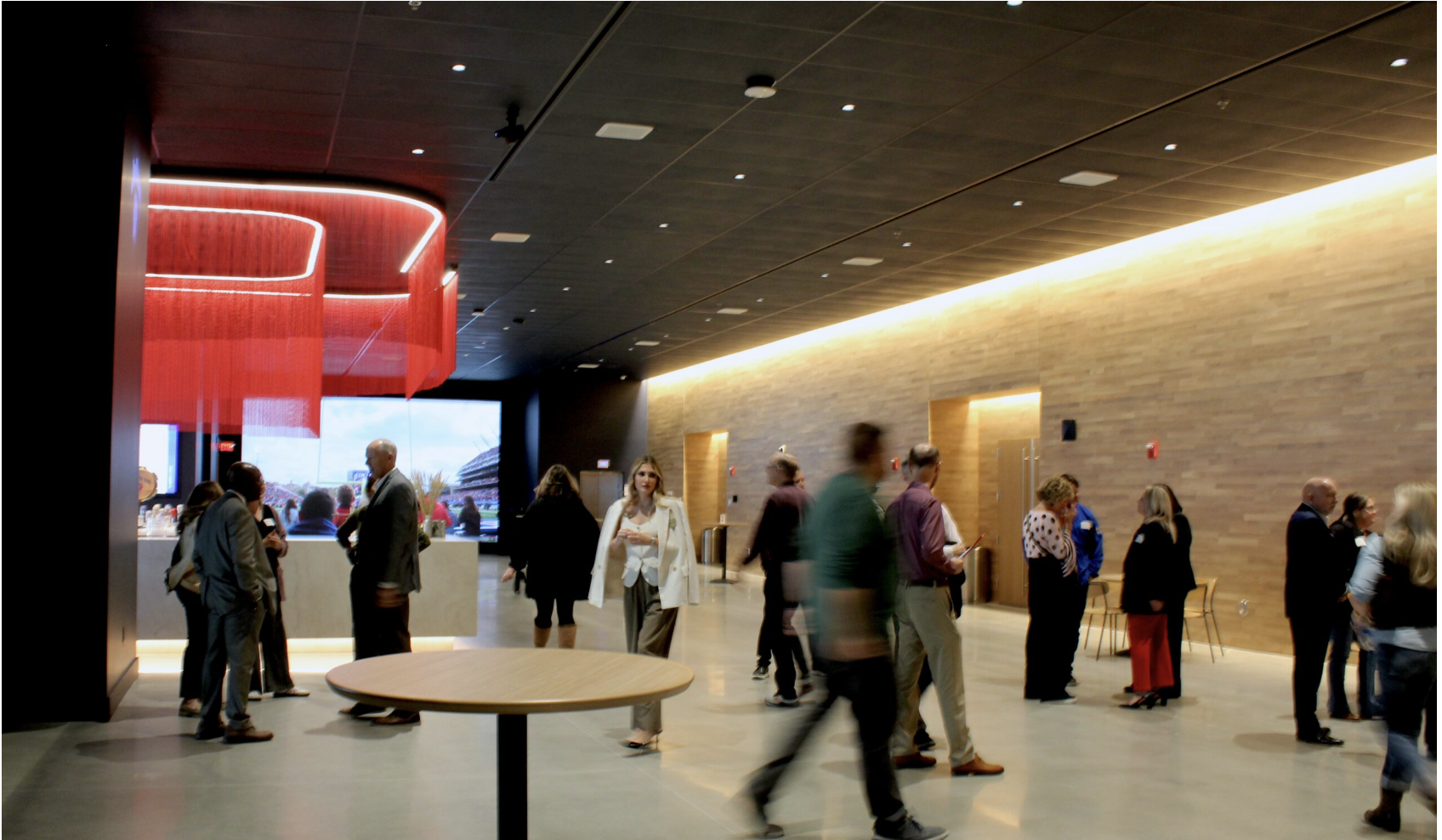 People gather in the University of Kansas Conference Center, which opened in Lawrence, Kansas on Nov. 12, 2025. It will host galas, parties, graduations, conventions and trade shows, said KU Chancellor Doug Girod. (Photo by Anna Kaminski/Kansas Reflector)