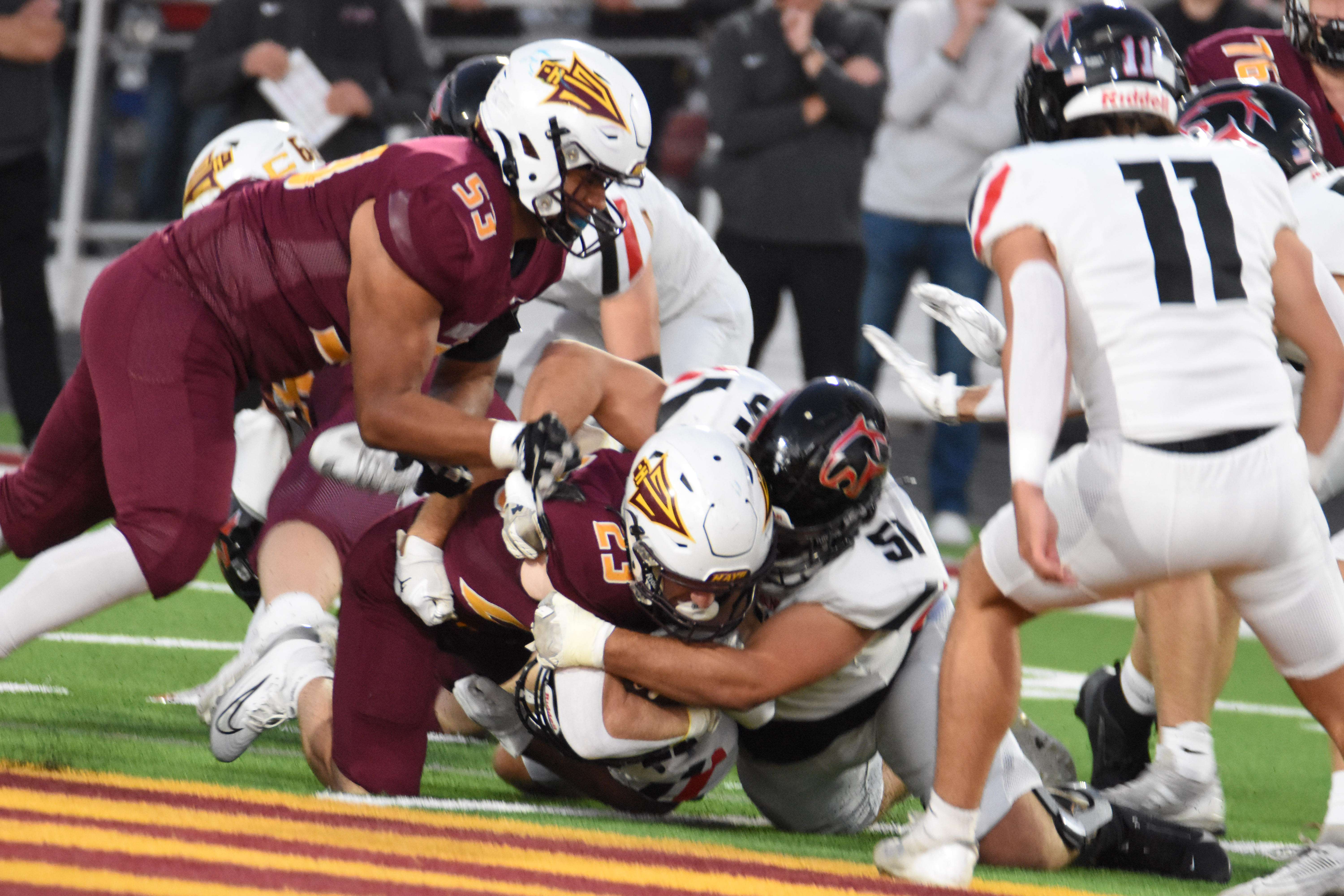 Panther senior Trenton Kern (51) wraps up Hays running back Holden Lind during the regular-season meeting in October.
