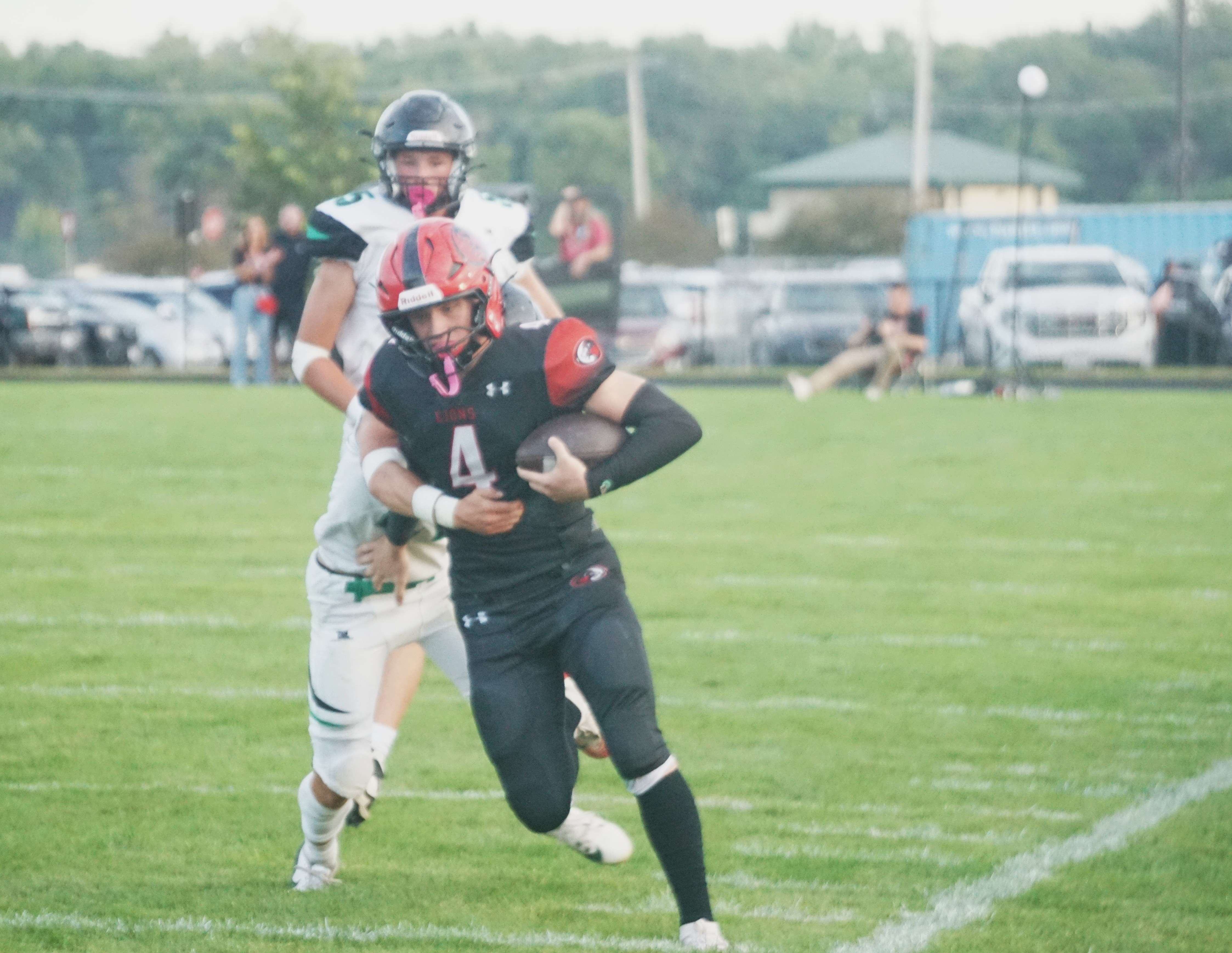 St Joseph Christian's Brayden Hoffan (4) breaks away from a tackle along the sideline/ Photo by Matt Pike