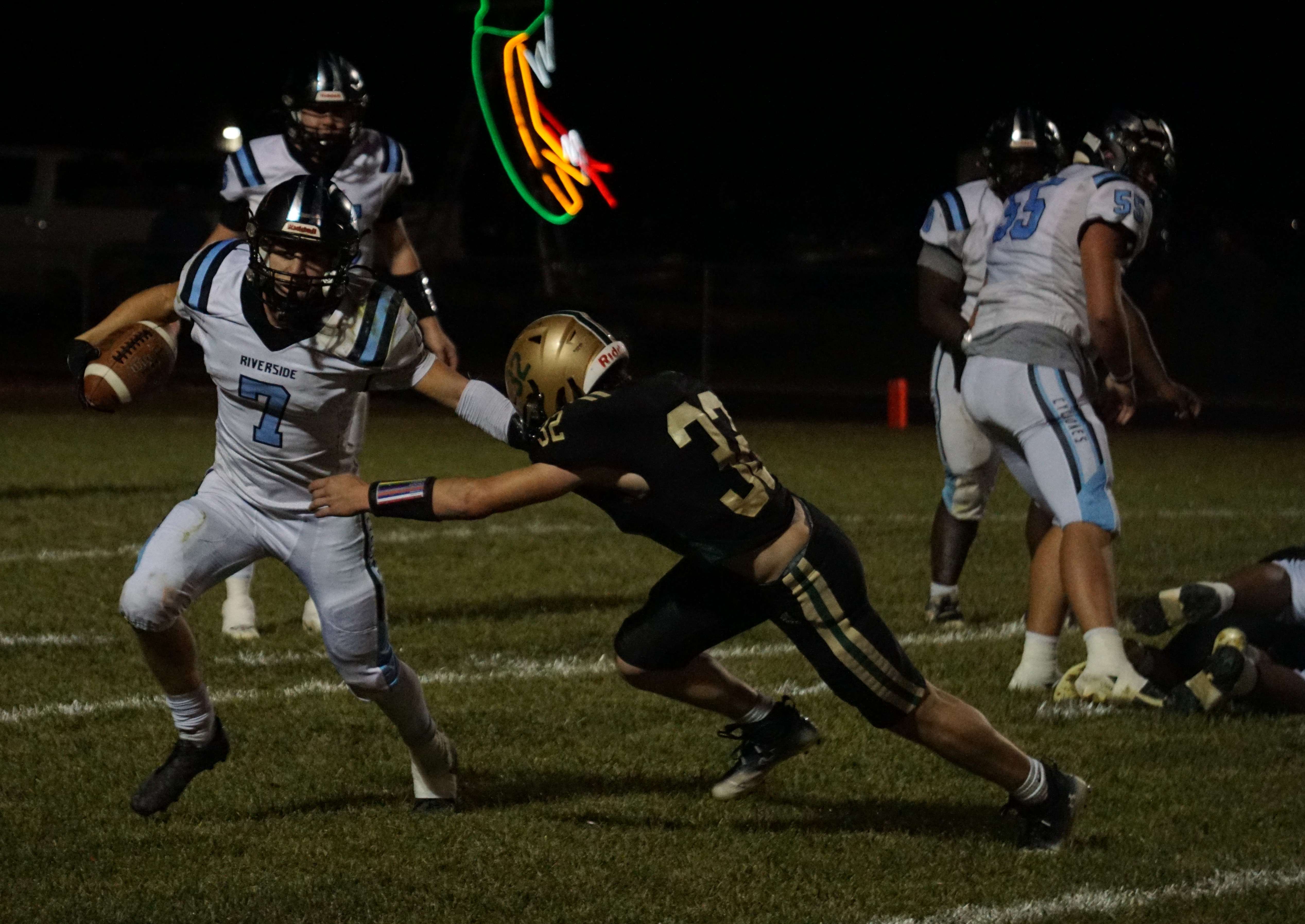 Chase Hewins (7) stiff arms Tatum Eisenbarth (32)/ Photo by Matt Pike