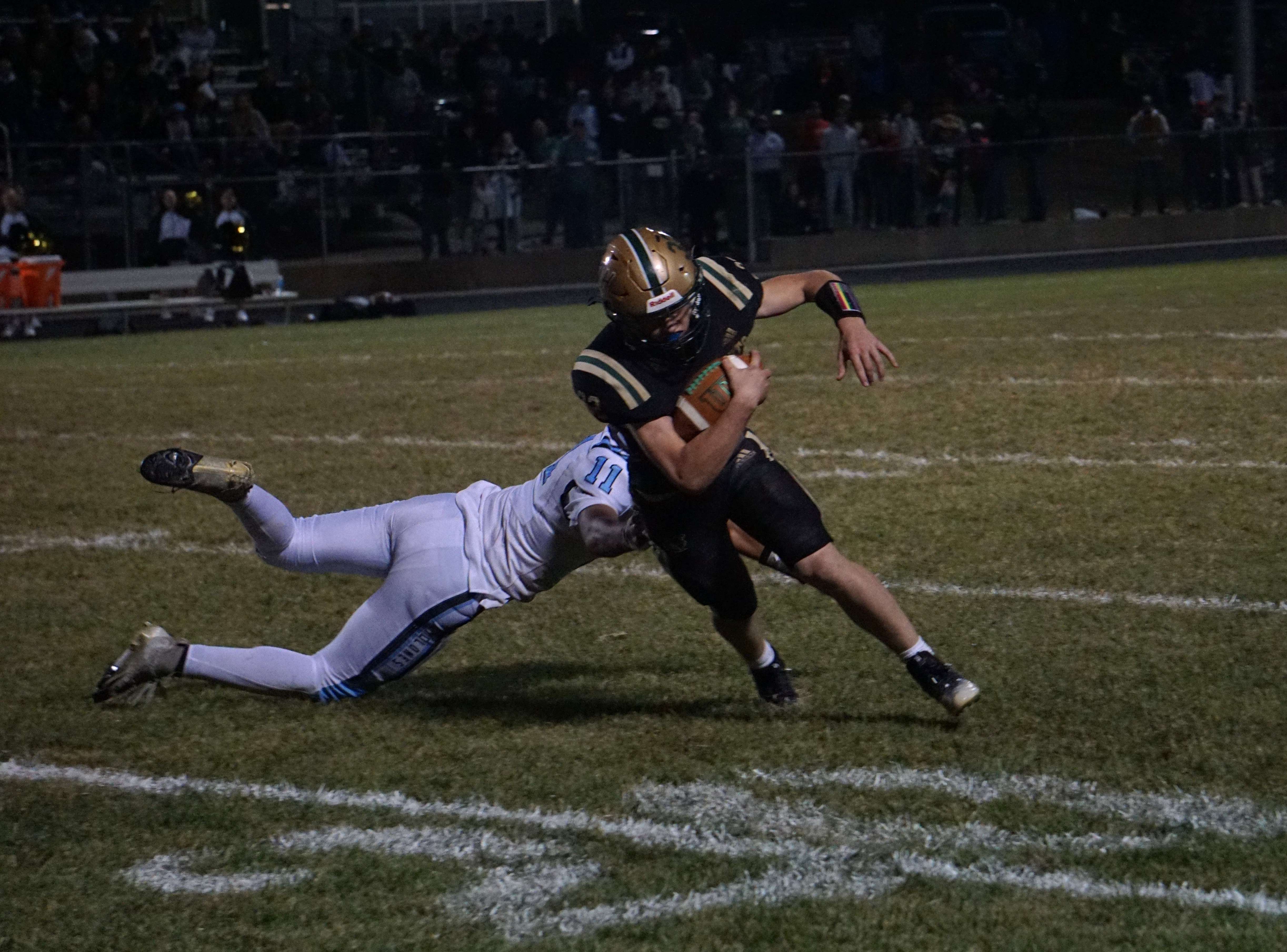 Tatum Eisenbarth (32) breaks out of a tackle by the diving Keagan Hughes (11)/Photo by Matt Pike