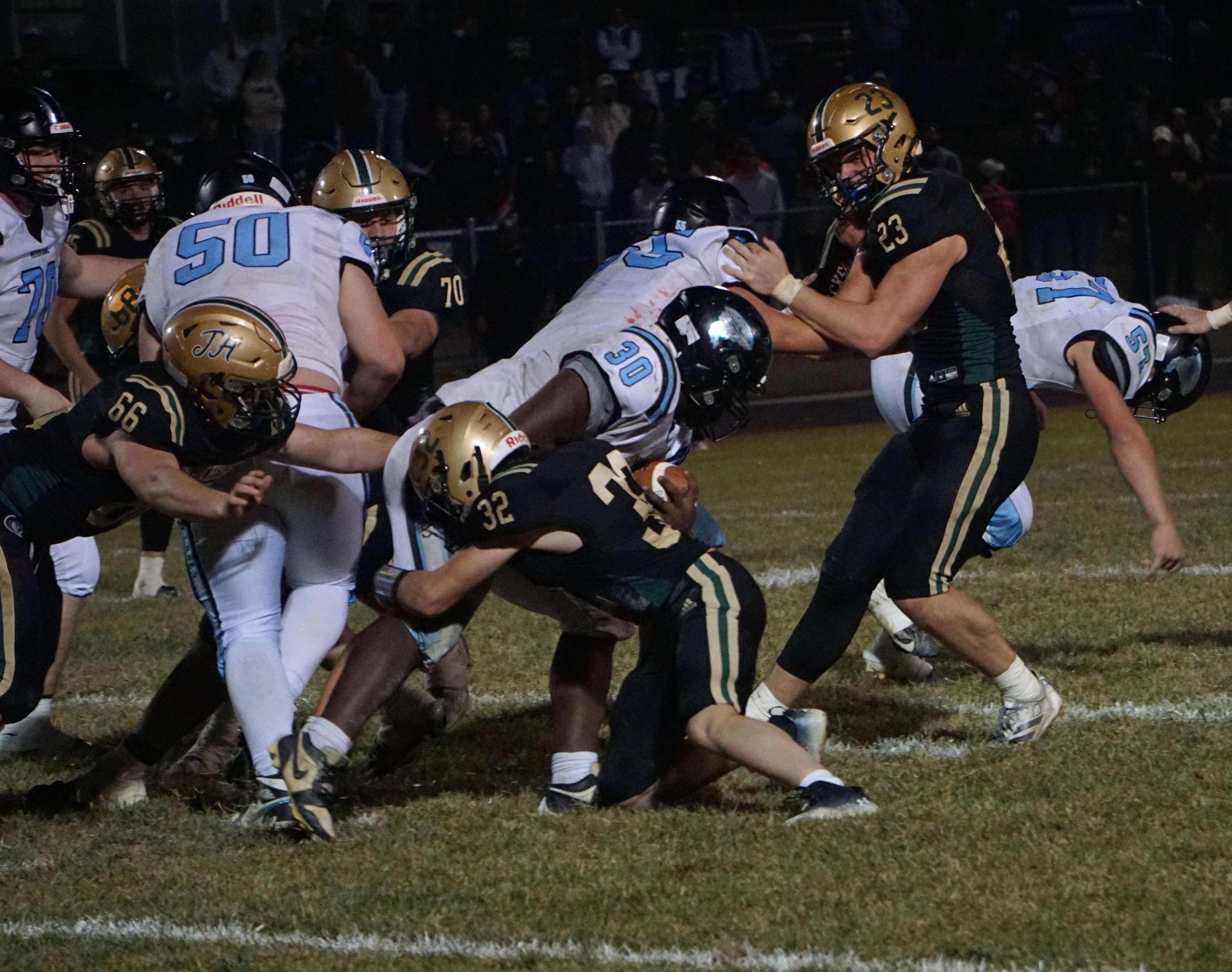 Elijah Moore (30) pushes through the line/ Photo by Matt Pike
