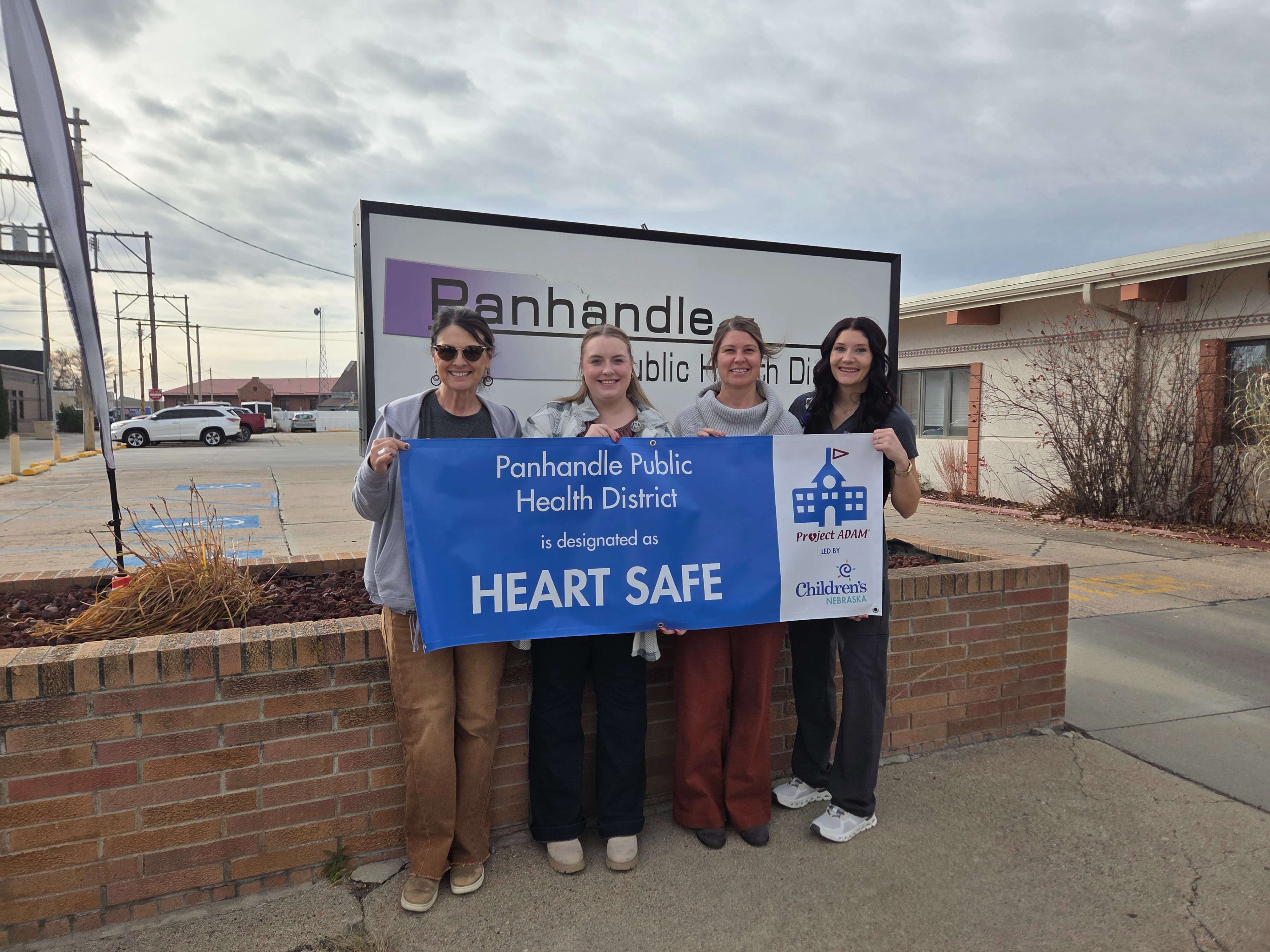 PPHD Certified Emergency Response Team (CERT) with their banner designation, (left to right) Tina Cook, RN; Allyson De Los Santos, RN; Kendra Lauruhn, RDH; Myrranda Kelley, RN, Lead Site Champion (courtesy Panhandle Public Health District)