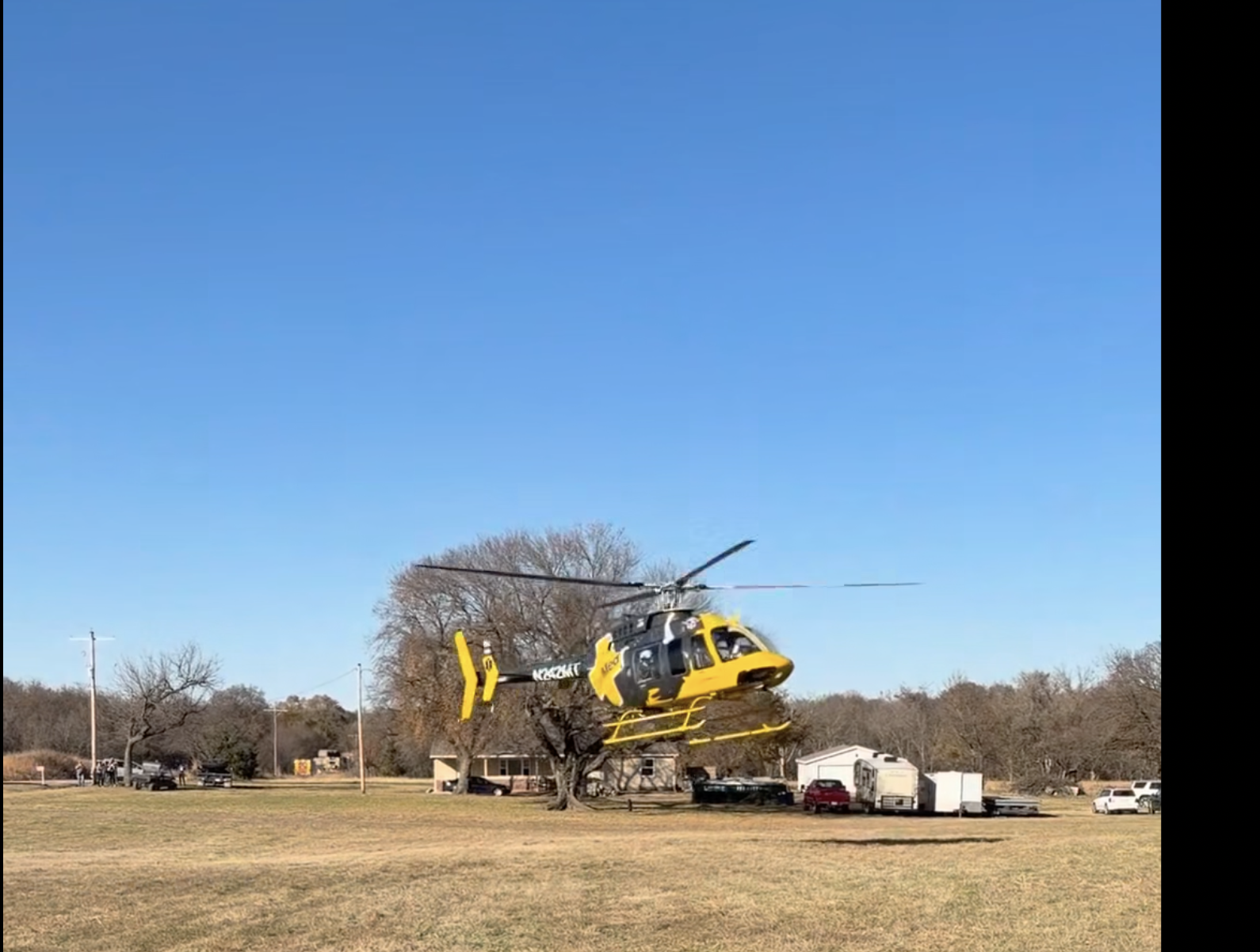 EagleMed 11 lands west of Burden to assist with the Sunday afternoon crash-Photo from Cowley County Fire Department video