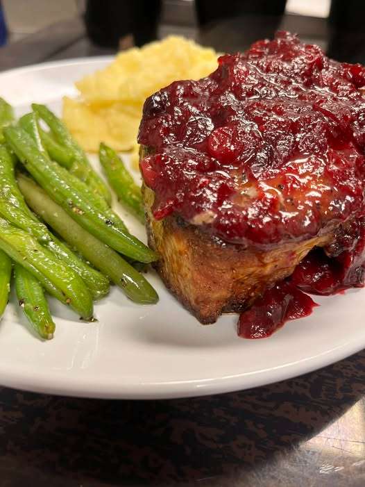 Pork chop with a cranberry reduction.