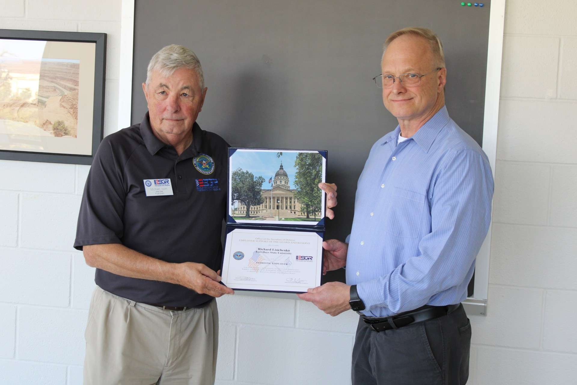 ESGR volunteer Mike Isom, left, presents the Patriot Award to Dr. Richard Lisichenko of Fort Hays State University. Courtesy photo