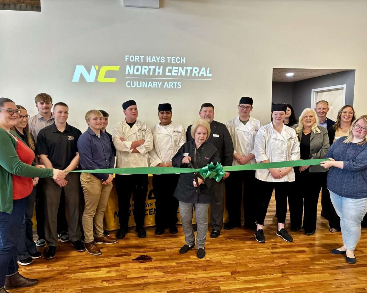 Wilma Power, Fort Hays State Tech | North Central culinary instructor, cutting a ribbon to celebrate the culinary arts program's new home at the Lb. Event Center & Catering. Photo by Tony Guerrero/Hays Post