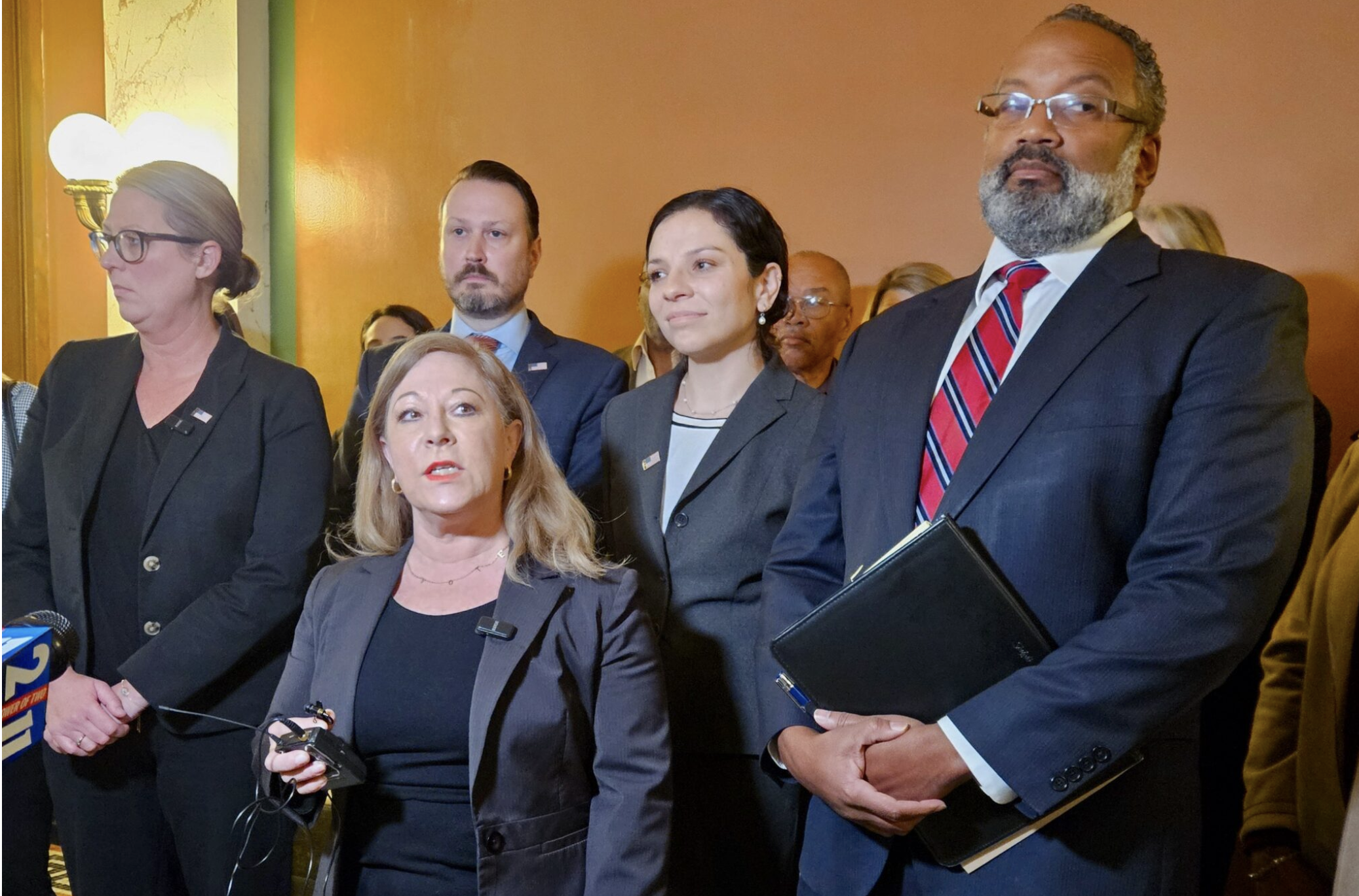  Denise Lieberman of the Missouri Voter Protection Coalition, center, speaks Wednesday about the Supreme Court hearings on laws requiring a government-issued voter ID and barring paid voter registration solicitors (Rudi Keller/Missouri Independent).