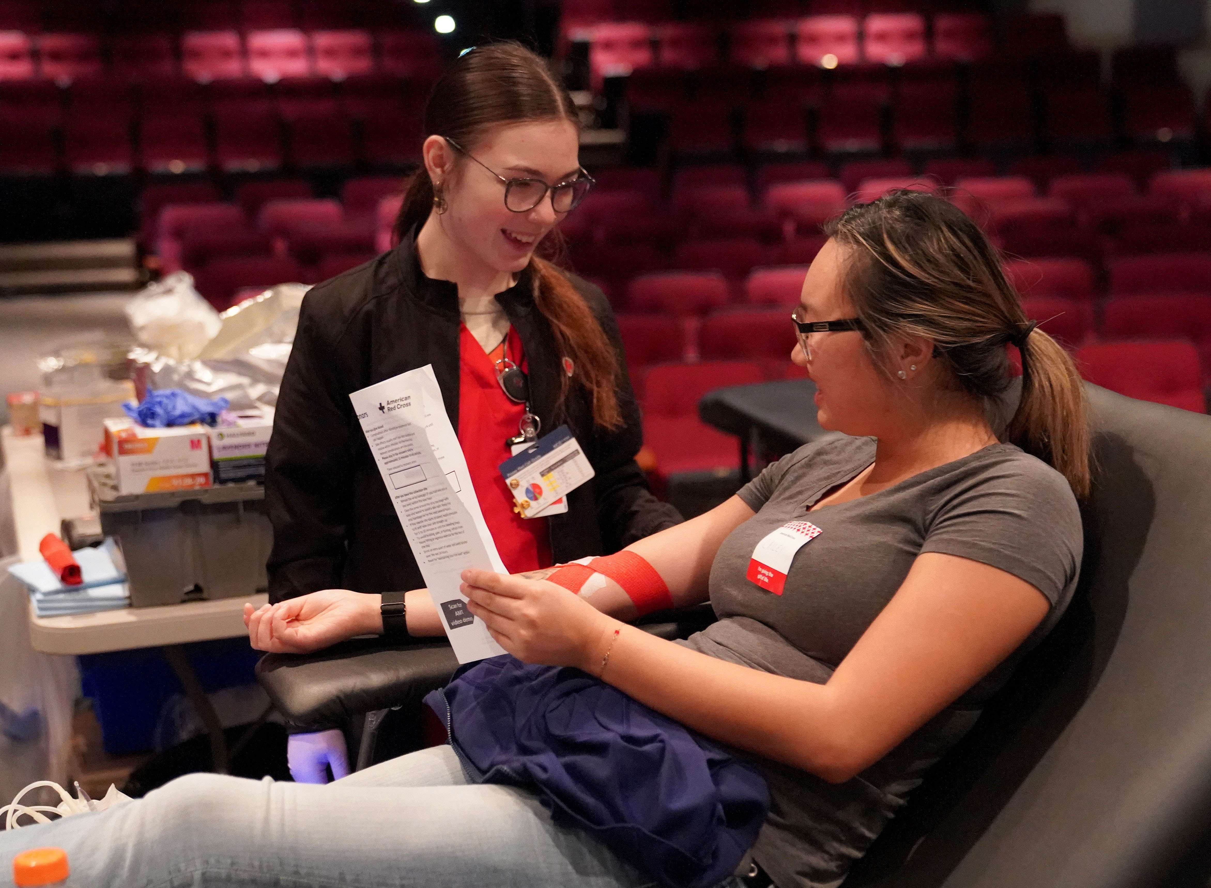 MPCC student Cailey Nutt gets instructions while giving blood at a September blood drive on NPCC South Campus. (Courtesy MPCC)