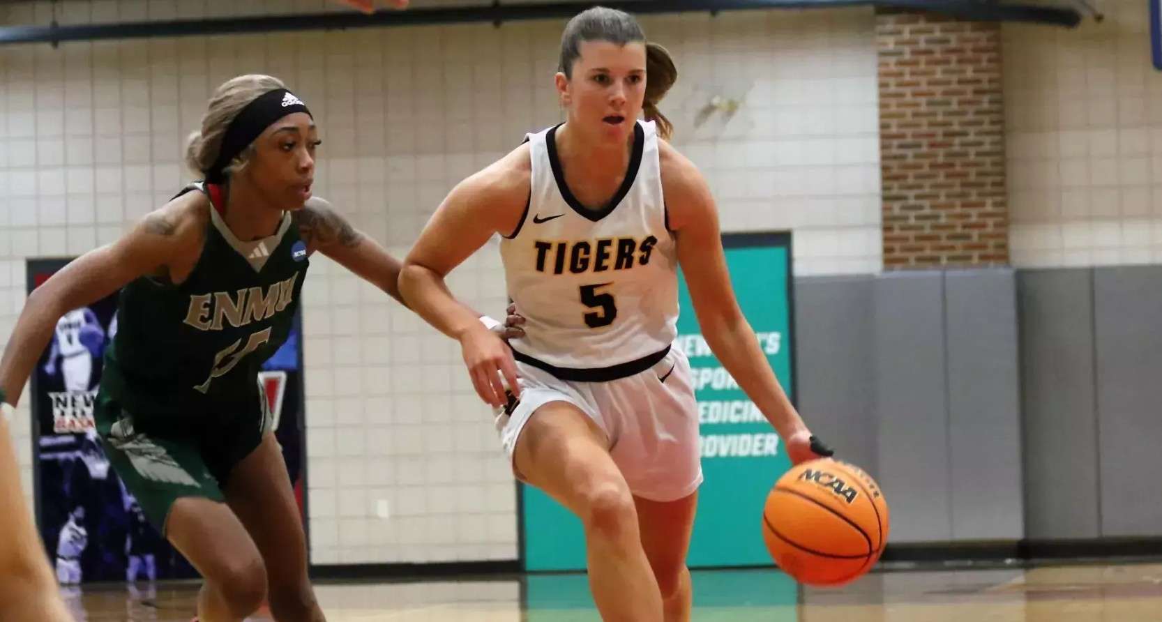 Fort Hays State point guard Brooke Loewe (5) brings the ball up the floor in while being guarded by Eastern New Mexico's Nataya Lockett (15)  in the second half of their game on Friday, November 21, 2025 in Wichita, Kan. (FHSU Athletics photo/Newman Athletics)