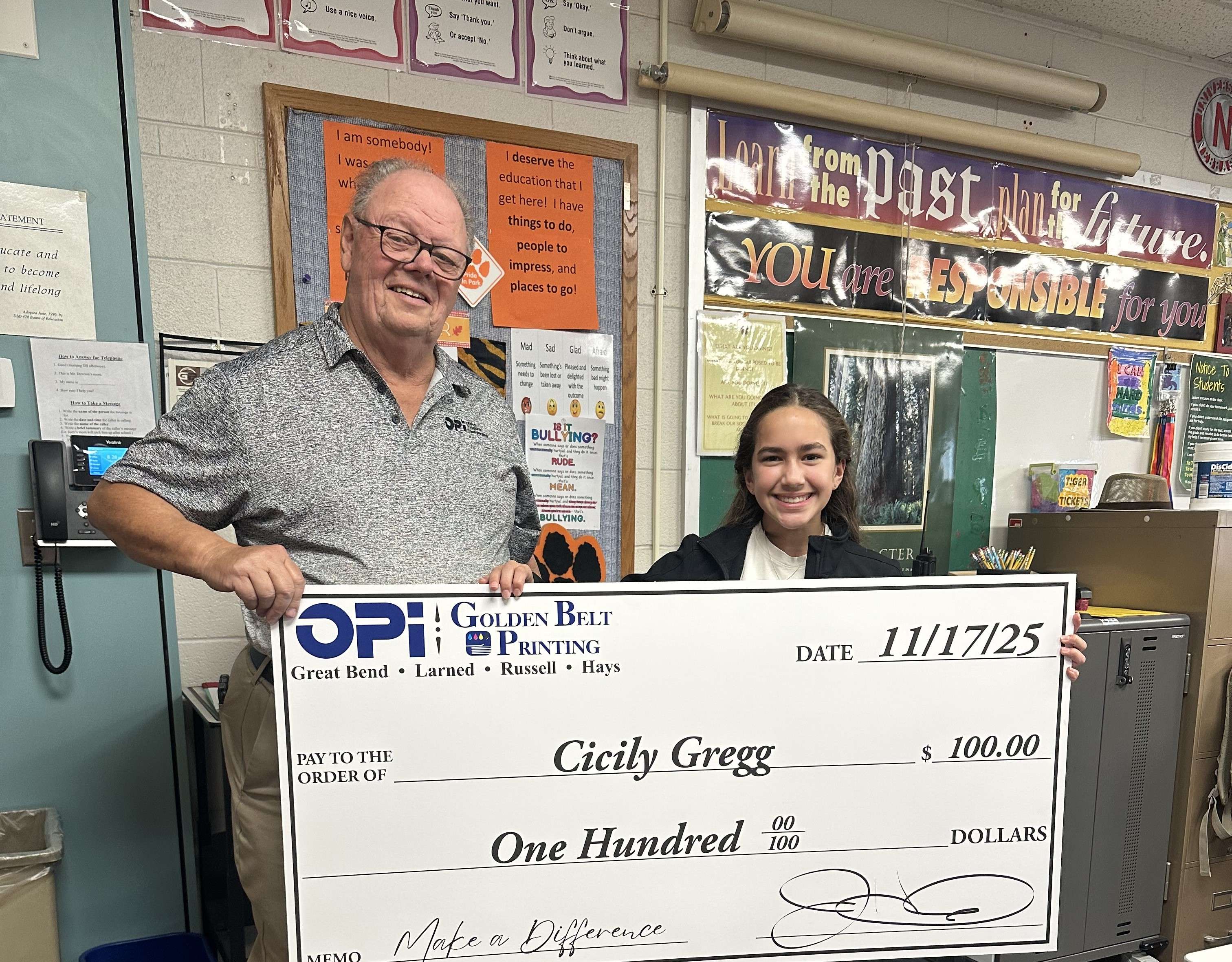 Park Elementary sixth grader Cicily Gregg was presented a giant $100 check from OPI &amp; Golden Belt Printing as the latest winner in Eagle Media's Make a Difference Contest.