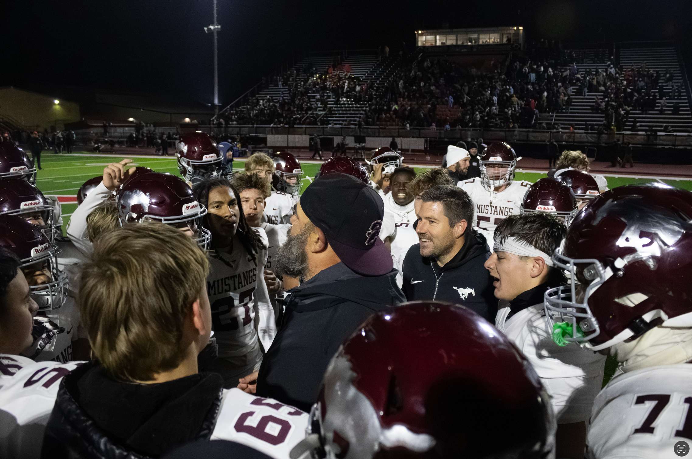 Salina Central huddles up around the coaching staff after beating Great Bend. Photo by Kaiden Comeau