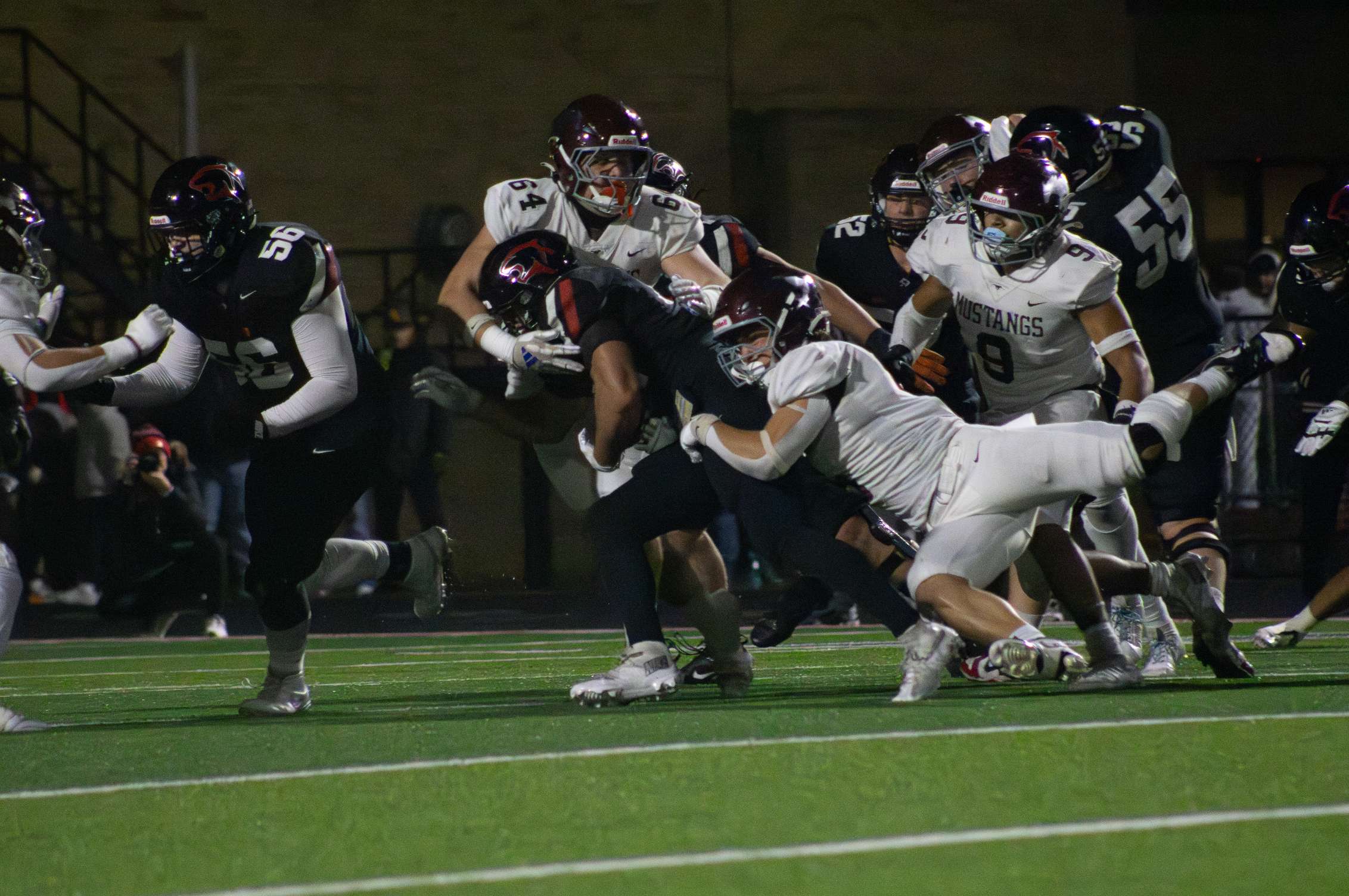 The Mustang defense brings down a Great Bend runner for a stop. Photo by Kaiden Comeau.