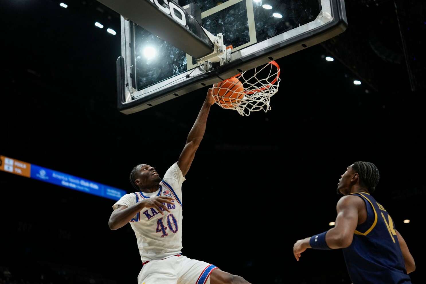 Kansas forward Flory Bidunga (40) dunks the ball against Notre Dame forward Kebba Njie during the first half of an NCAA college basketball game, Monday, Nov. 24, 2025, in Las Vegas. (AP Photo/Lucas Peltier)