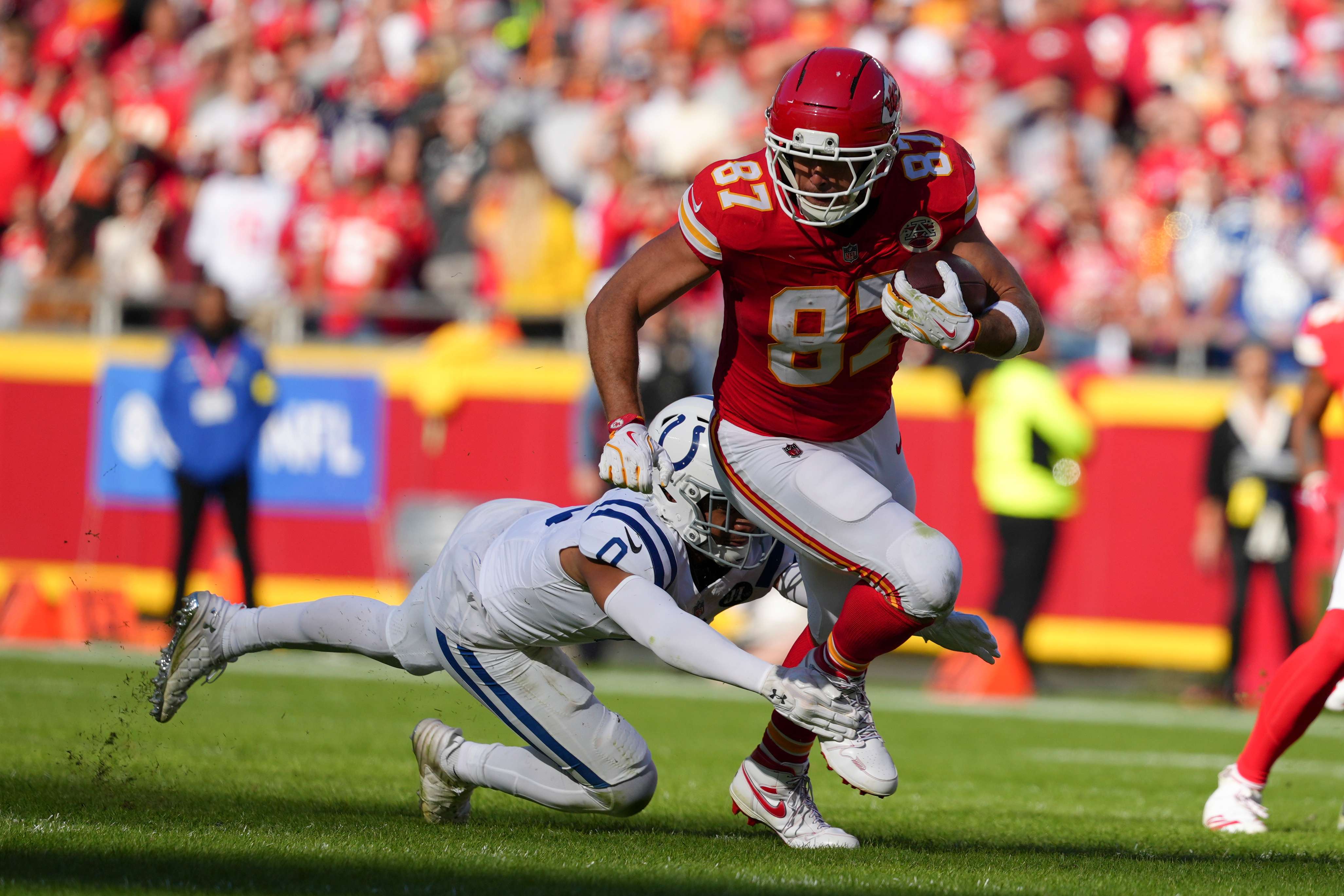 Kansas City Chiefs tight end Travis Kelce (87) is tackled by Indianapolis Colts safety Camryn Bynum (0) during the first half of an NFL football game Sunday, Nov. 23, 2025, in Kansas City, Mo. (AP PhotoEd Zurga)