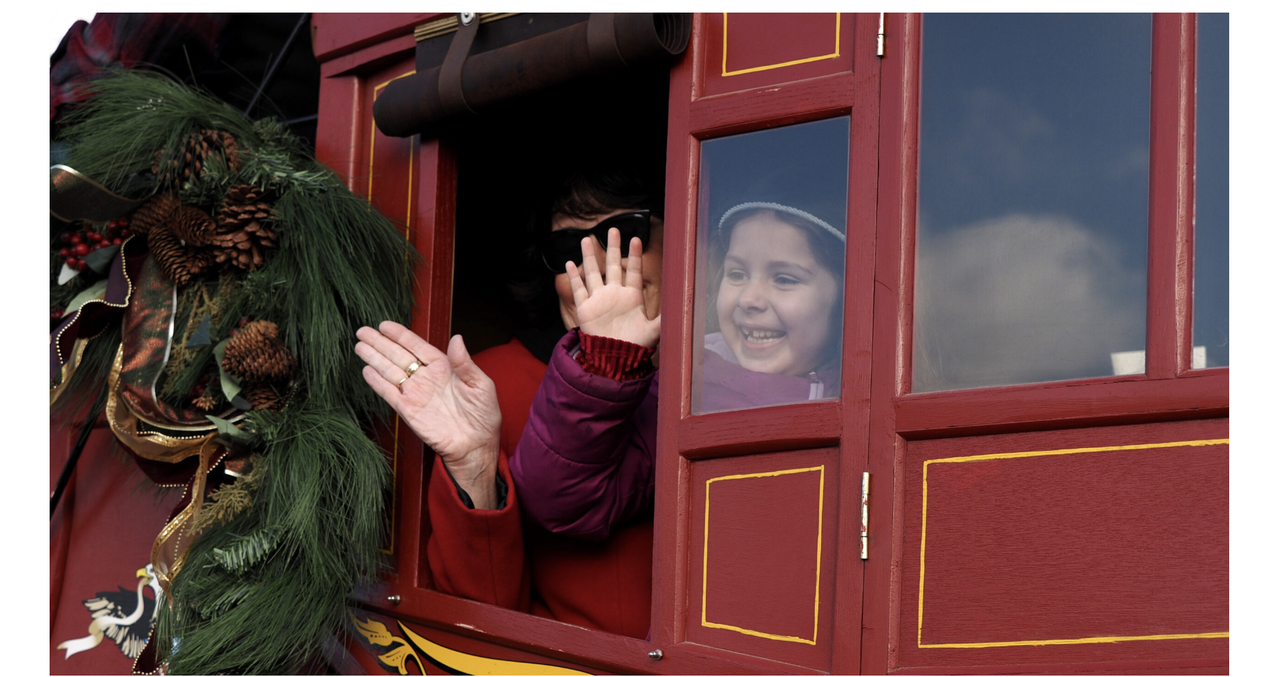 Charlotte Cooper rides a replica of a Wells Fargo stagecoach to deliver Gov. Laura Kelly’s Christmas decorations on Nov. 25, 2025, at Cedar Crest in Topeka. (Photo by Grace Hills for Kansas Reflector)