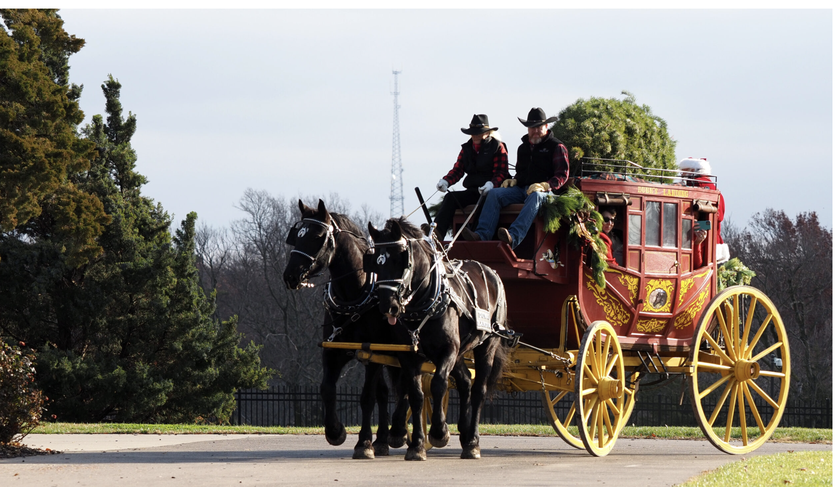 A Wells Fargo stagecoach replica proceeds up the driveway of the governor’s mansion to deliver donated Christmas decorations on Nov. 25, 2025. (Photo by Grace Hills for Kansas Reflector)